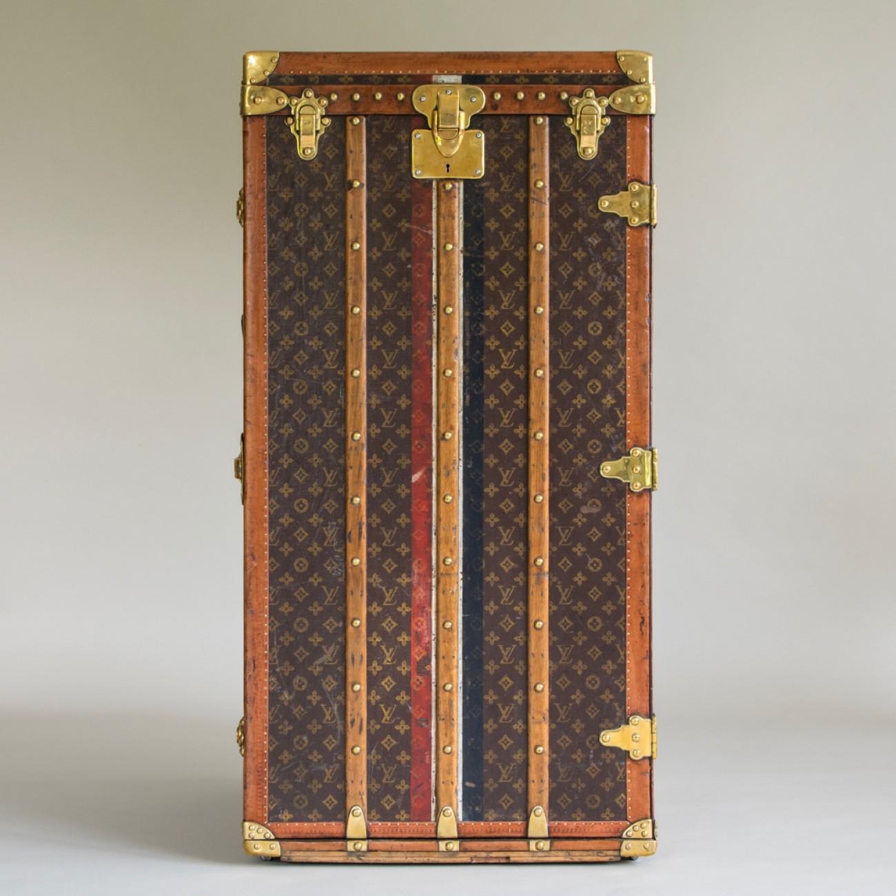 An exceptionally Large Louis Vuitton Wardrobe Trunk in LV Monogram with lozine trim and original interior fittings providing hanging space, circa 1916. The substantial leather handles of this trunk have been replaced to the original pattern.

Louis