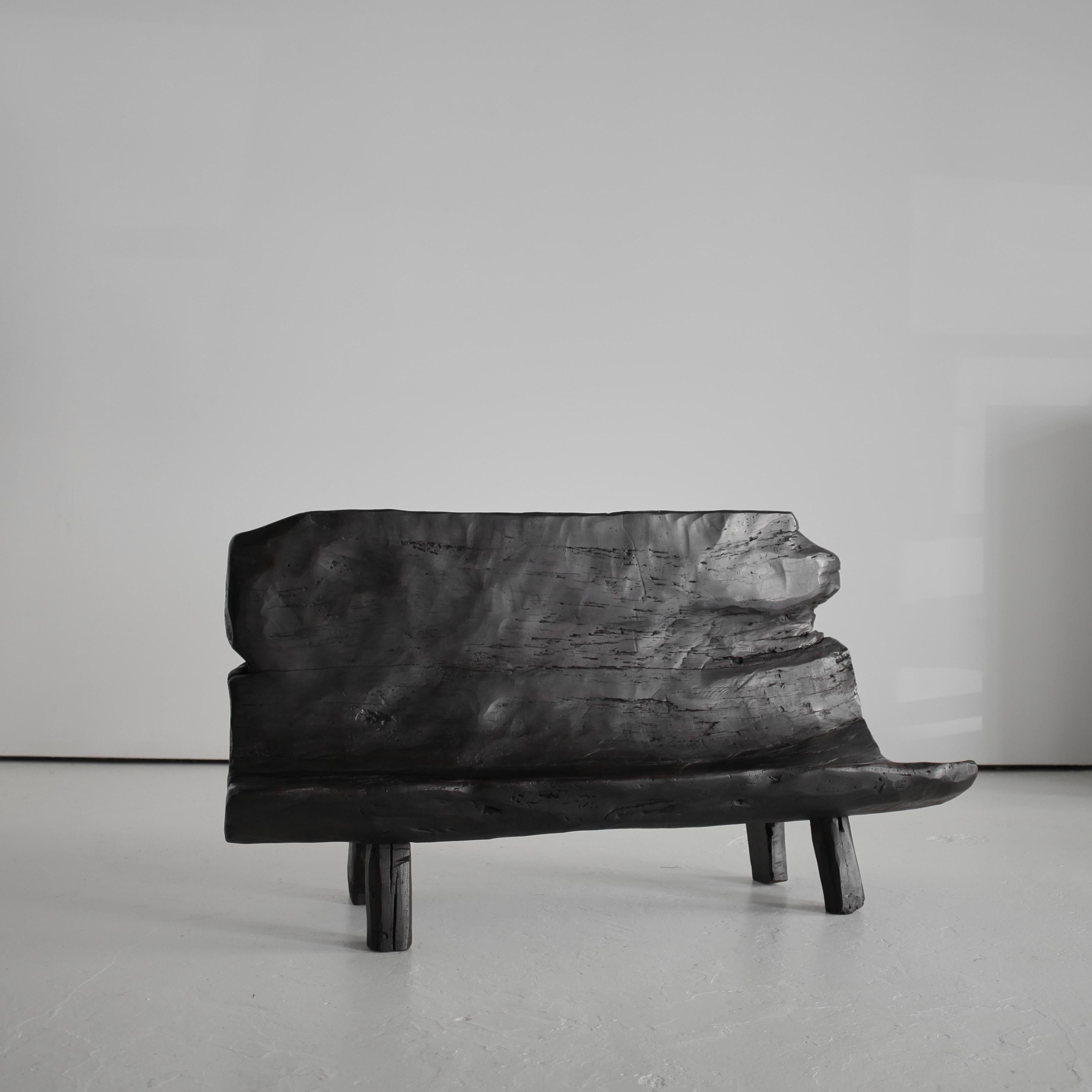 A super rare dug-out bench from the mountains of northern Portugal.

Hollowed out from a signal piece of walnut.

Heavily patinated with age old repairs.