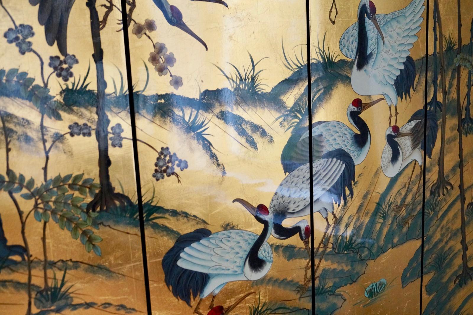 Four-panel screen/room divider crane birds
France, Art Deco period.

With generous applied gold leaf and gloss lacquered finish.
Extremely decorative piece of applied art. Beautifully detailed and hand painted.
Good condition. Some minor