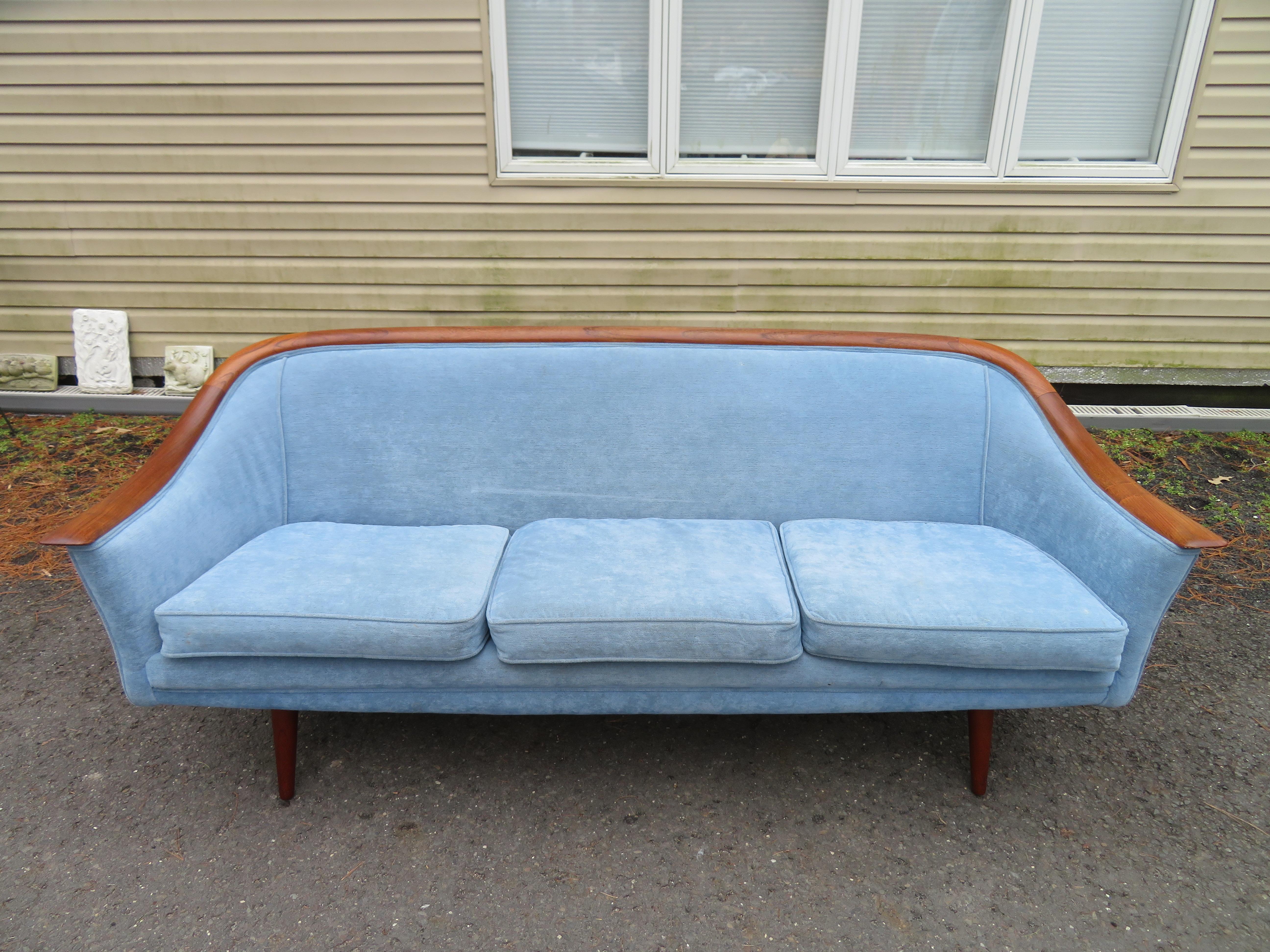 Rare T. H. Robsjon-Gibbings for Widdicomb sculptural wooden edge sofa. Just look at that sexy curved teak edge along with tall tapered legs-so well designed! This sofa measures 29