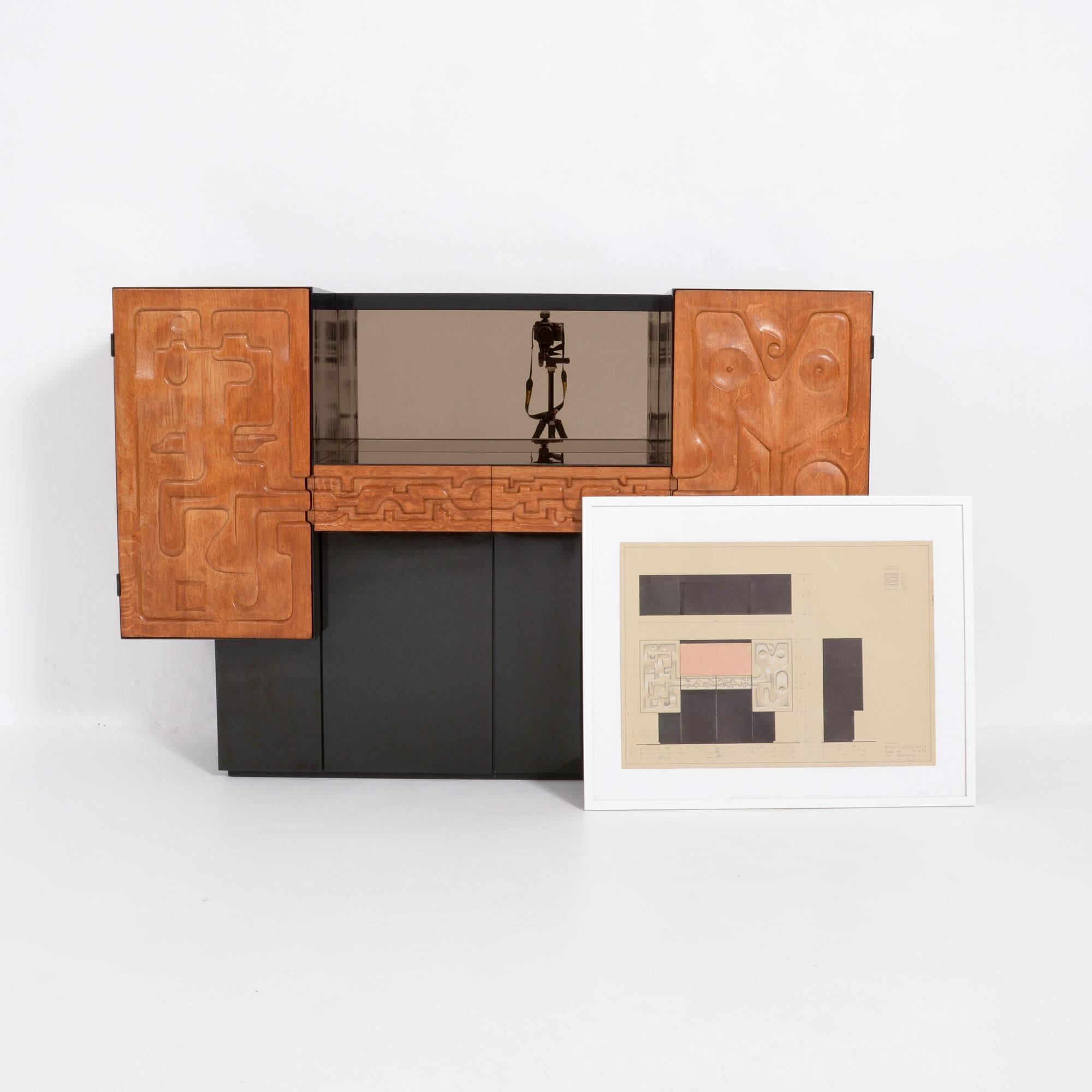 This bar cabinet was created by the Belgian furniture designer Paul Ghekiere in 1982.
We have the original detailed design drawing of the cabinet, signed and dated.
This one-off piece of furniture was handmade. The doors and drawers are sculpted