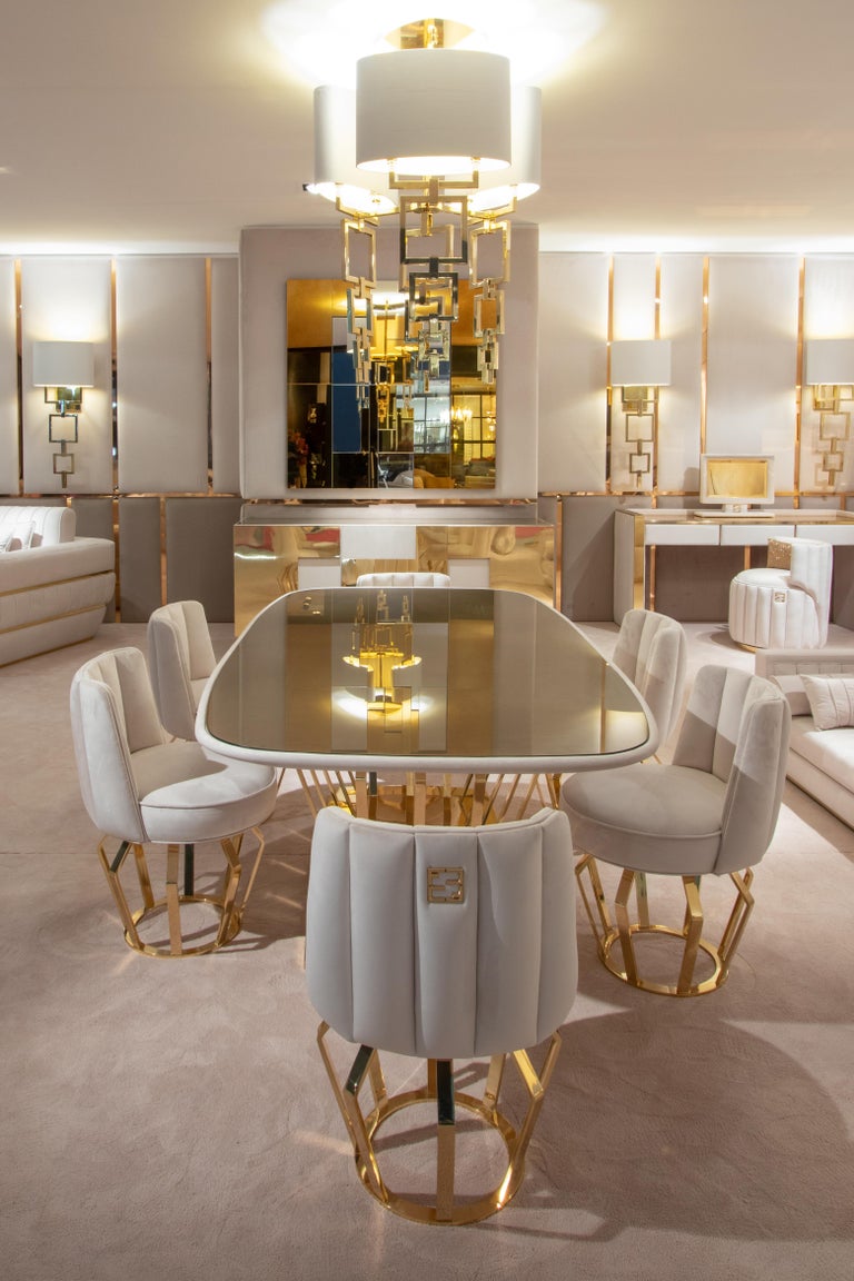 Exclusive contemporary gold-plated signature dining table set. This extraordinary design offers a sophisticated contemporary dining table. Together with six supremely comfortable dining chairs, each beautifully upholstered and padded with a luxury