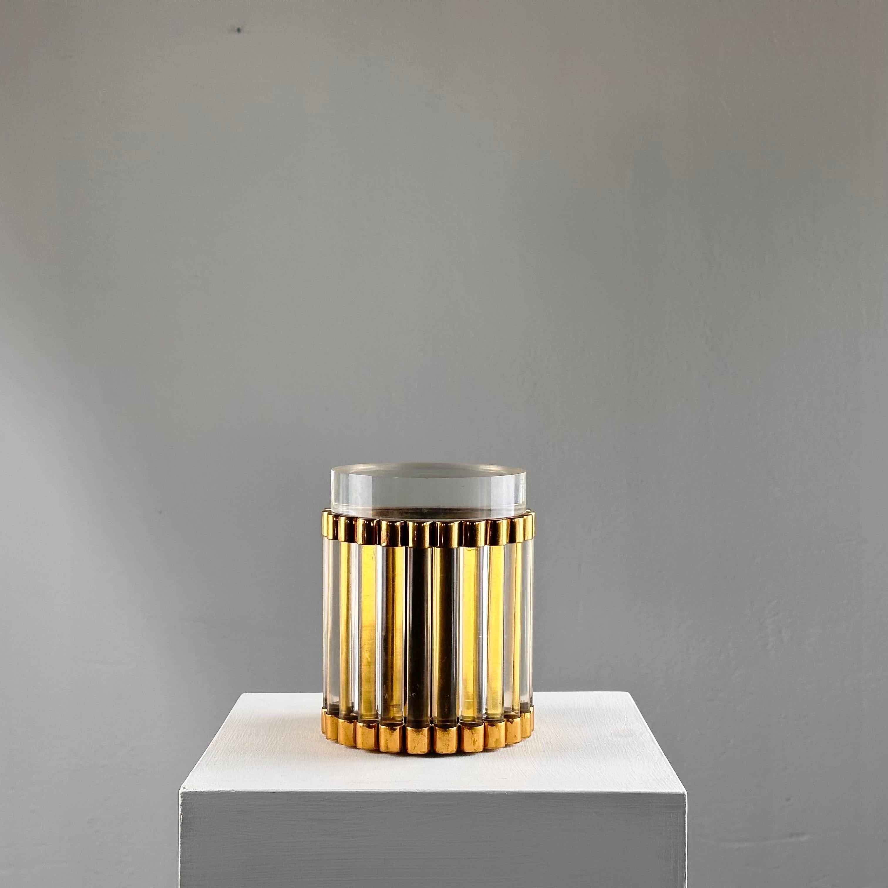 Discover the epitome of mid-century elegance with this exquisite Round Box / Bottle Basket by renowned Italian designer Gabriella Crespi. Crafted in the glamorous 1970s, this unique piece seamlessly merges form and function, showcasing Crespi's