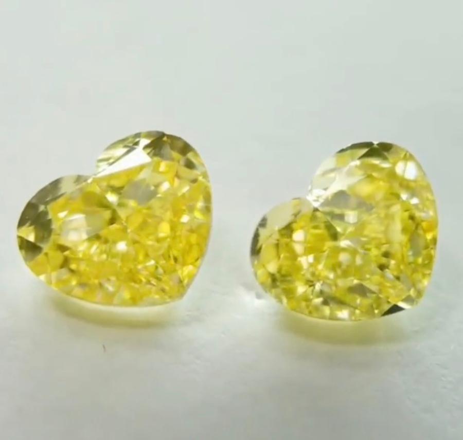 An exquisite pair of GIA certified ct 2 of natural fancy intense yellow diamonds heart cut, 
VS2 clarity.
Complete with GIA certificates.
Special discount price.