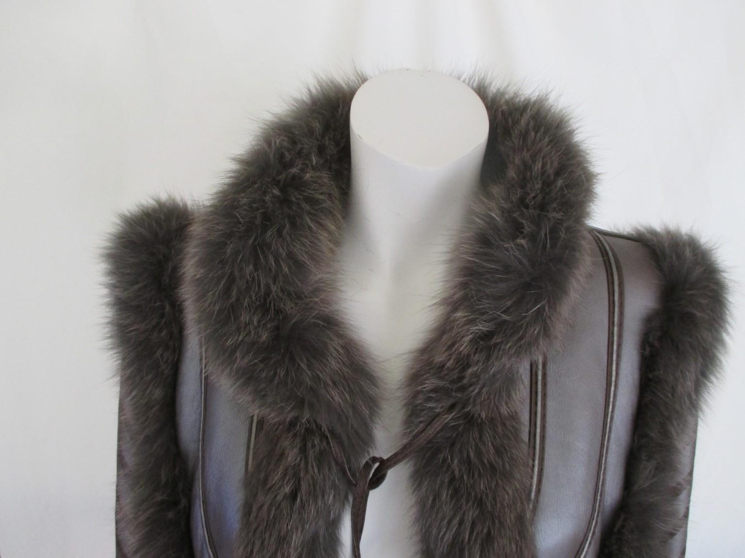 This vintage lamb fur coat is trimmed with fox fur and bronze gold brown leather chevron 

We offer more exclusive fur items, view our frontstore

Details:
With 2 leather pockets, 2 fringe closures and 1 at the collar.
Pre owned condition
Very