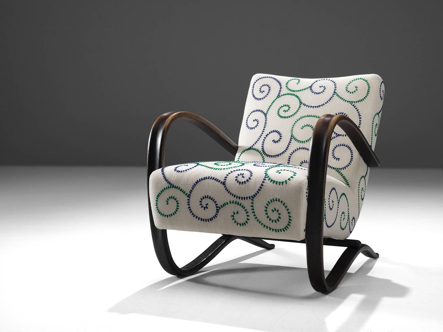 Jindrich Halabala, lounge chair, white fabric embroidered with green and blue in Jupe by Jackie Home and stained beech, Czech Republic, 1930s. 

This Halabala chair has been upholstered in collaboration with Jupe by Jackie Home collection. The chair