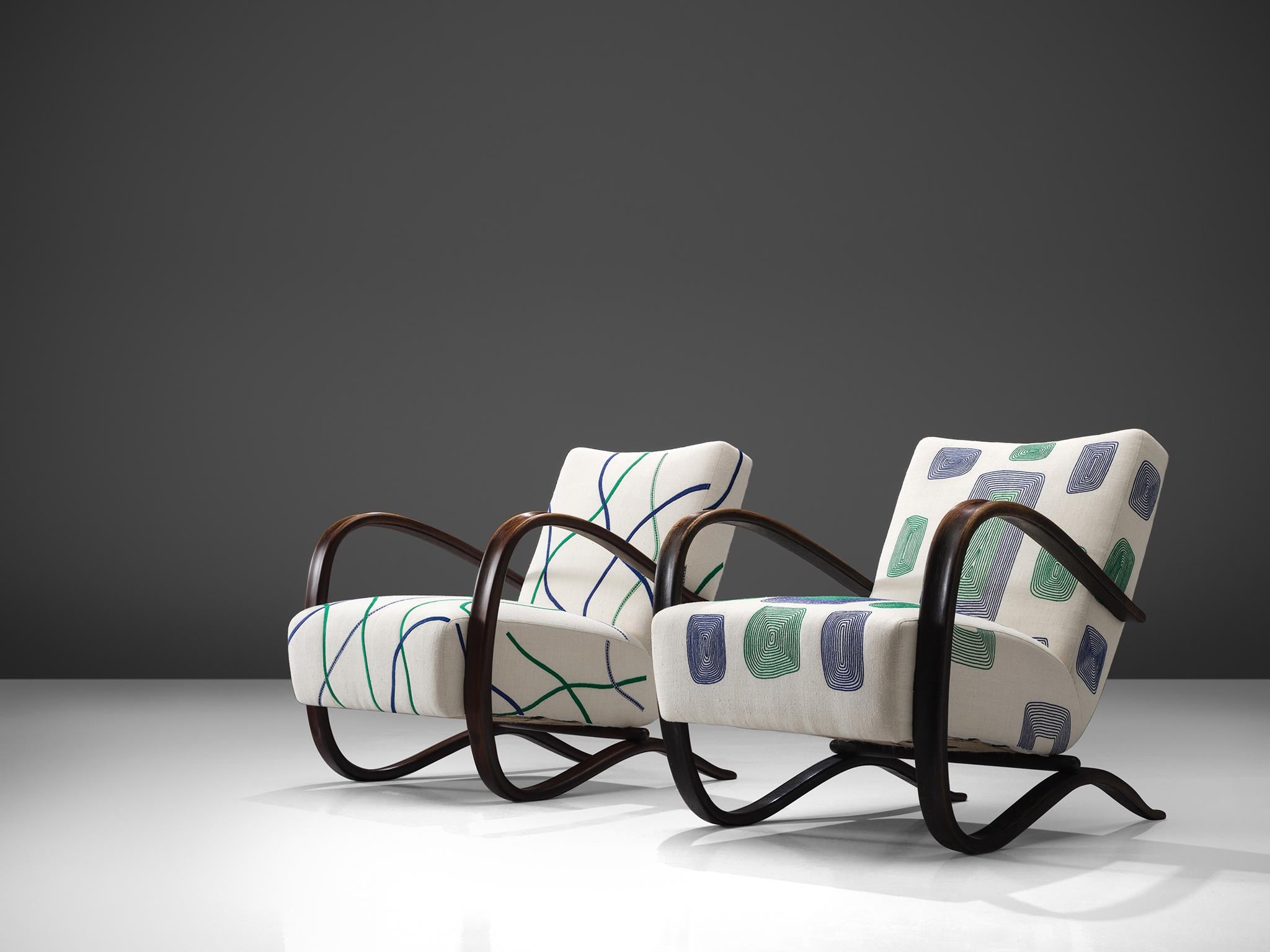 Jindrich Halabala, lounge chairs, graphical white and green fabric and stained beech, Czech Republic, 1930s. 

This extraordinary pair of Halabala chairs is has been upholstered in collaboration with the Jupe by Jackie Home collection. The chair