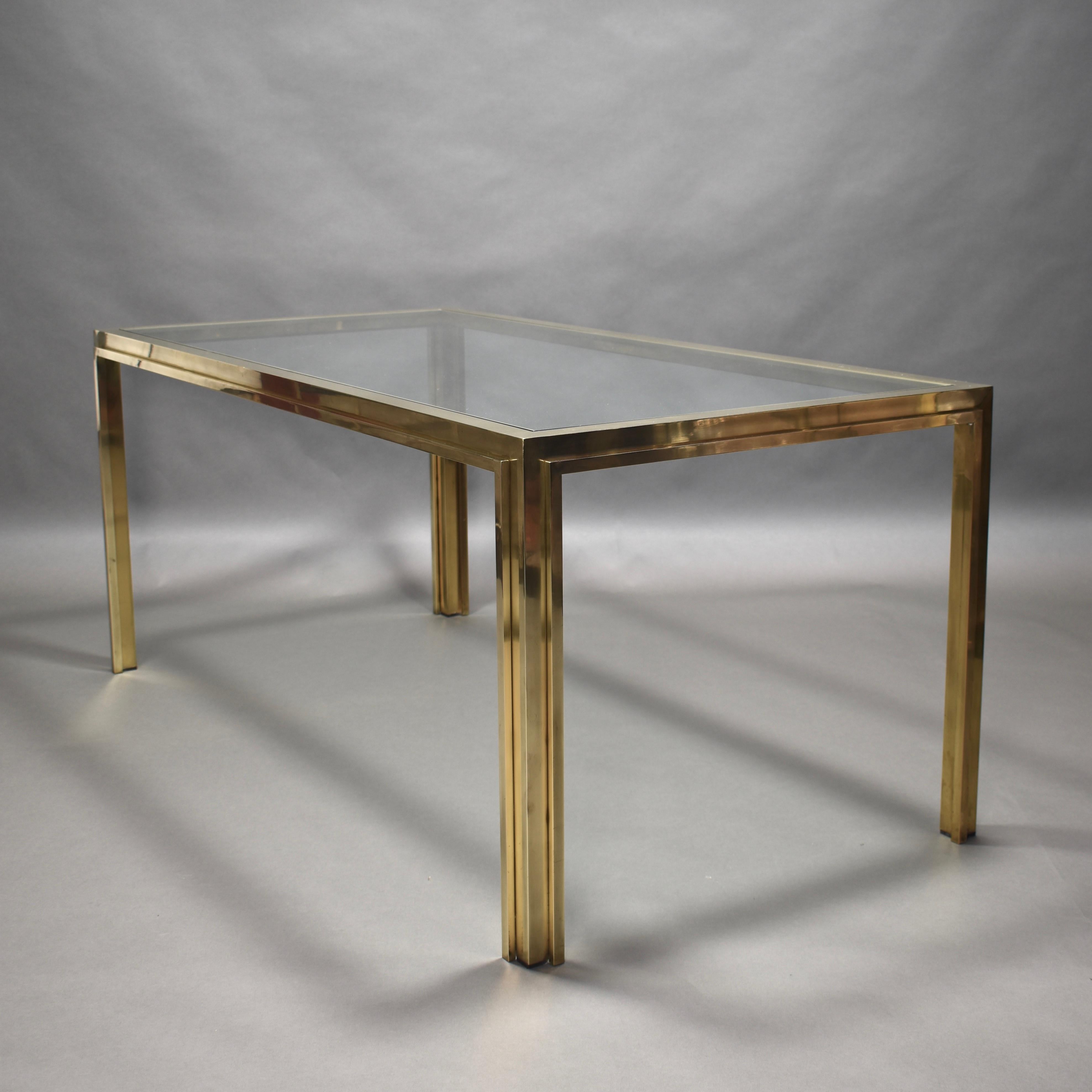 Gorgeous dining table in brass and clear glass, Italy, 1970s.
Amazing, minimalistic and clean design features.
! This listing is for just the table and not the chairs ! Chairs are available for sale.

The table is made of solid brass and clear glass