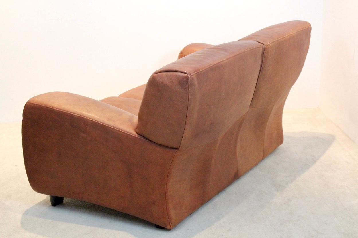 Very nice and comfortable natural cognac leather sofa named 'Fatboy' handmade by the Italian company Molinari in the 1980s. The leather is very thick neck-leather and has a very nice used patina. This is the two-seat version. Really a joy to sit in.