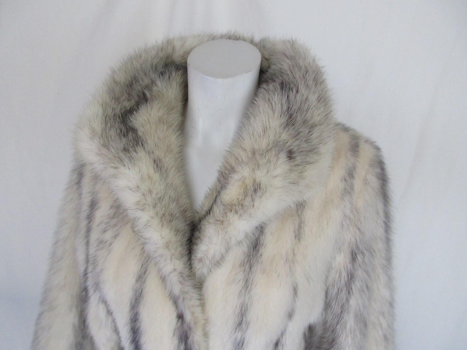 This vintage coat is made of rare kohinoor/cross mink fur with a beautiful black lining

View our storefront for more mink fur coats and other vintage items.

Details:
With 2 pockets, 3 closing hooks and a collar button
Belt is not inclusive in this