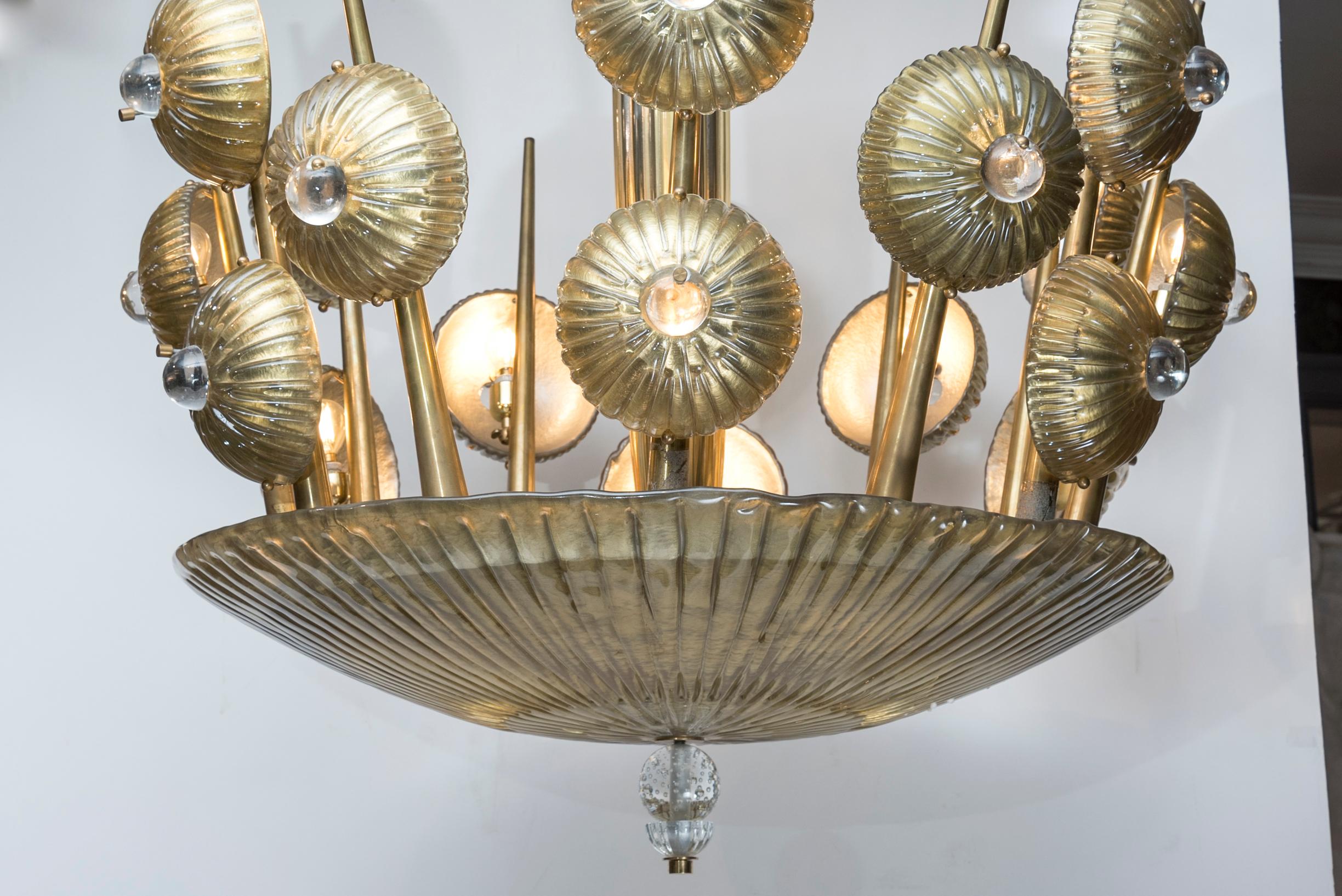 This vintage chandelier was entirely handcrafted in Italy in the 1970s. It is made in a glamorous design, composed of twelve arms and eighteen light bulbs.