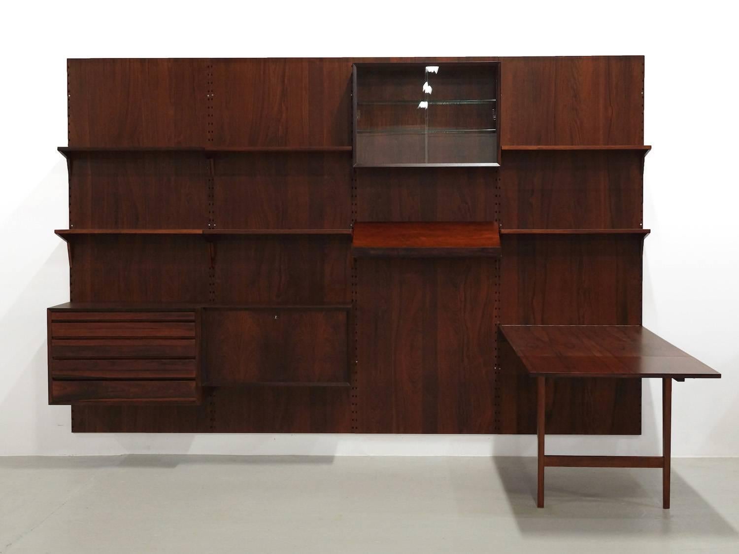 Beautiful modular wall unit from Poul Cadovius for Cado, Denmark, 1950s in Mahogany
This four unit modular wall systems can be built in any way you want it, to make it your own. 
The extendable table this unit is something unique that we have never