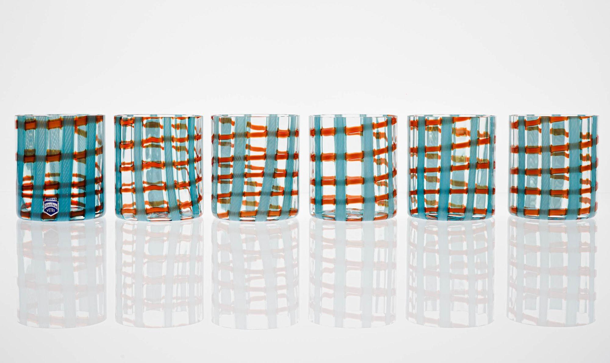 Special and exclusive full set of 6 Murano tumblers, Made by Cenedese.

The pattern of these glasses is a special technique used also by Venini at the time and goes under the name of Tartan, the criss-crossed fabric used on quilts.

Here Amelio