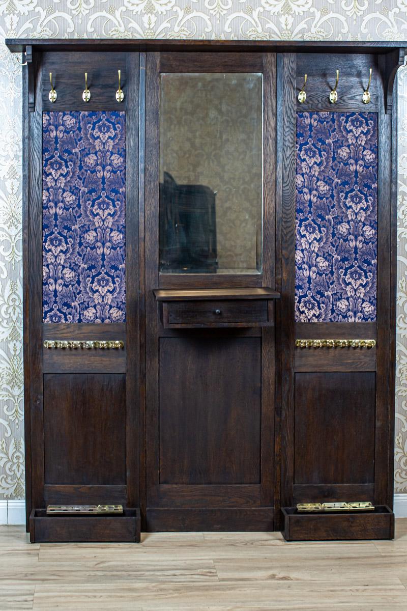 Exclusive Wardrobe from the Early 20th Century with Blue Decorative Elements

We present you this piece of furniture in the form of a wall with a base for umbrellas and a drawer for shoe brushes and shoe polish. The whole piece is circa 1910.
The