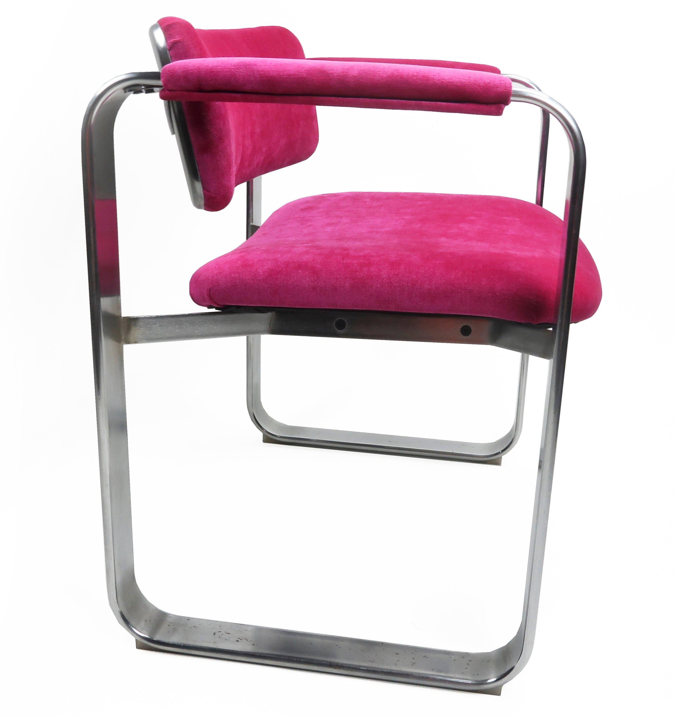 A dazzling Scandinavian Modern executive armchair by famed Finnish designer Eero Aarnio for Mobel Italia (1968). The frame has a satin chrome finish with a stainless back. And new hot pink/fucshia chenille upholstery on the seat, back and arms.
 
