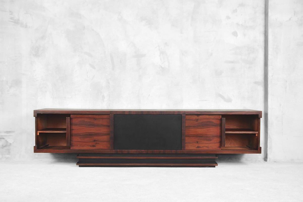 This Bauhaus-style low executive sideboard was manufactured in Germany during the 1950s. It was finished in two kinds of wood: the chest is made from birch and the front is made from rosewood with regular and strong grain. The piece features three