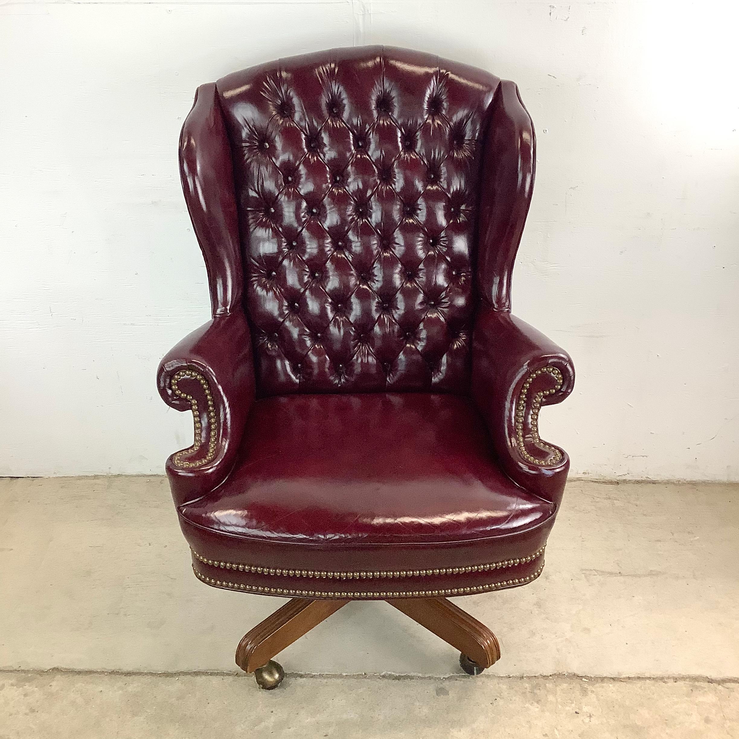 Elevate your workspace with the old-world sophistication of this burgundy leather executive chair, a seat fit for thinkers, creators, and leaders. Wrapped in supple leather and accented with button tufting and trim, this chair channels classic