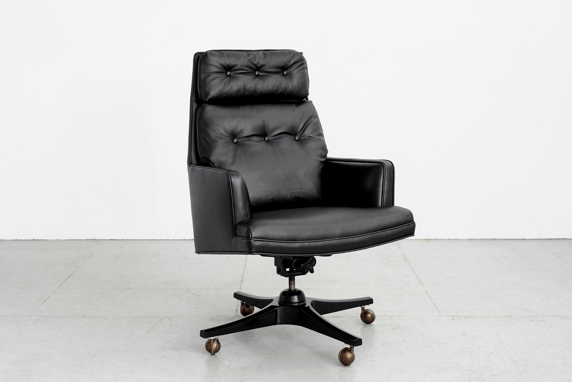 Handsome executive desk chair by Dunbar. Reupholstered in black leather with newly refinished black four star wood base. 
Original casters.
Nice large scale and very comfortable! Metal Dunbar label on underside.