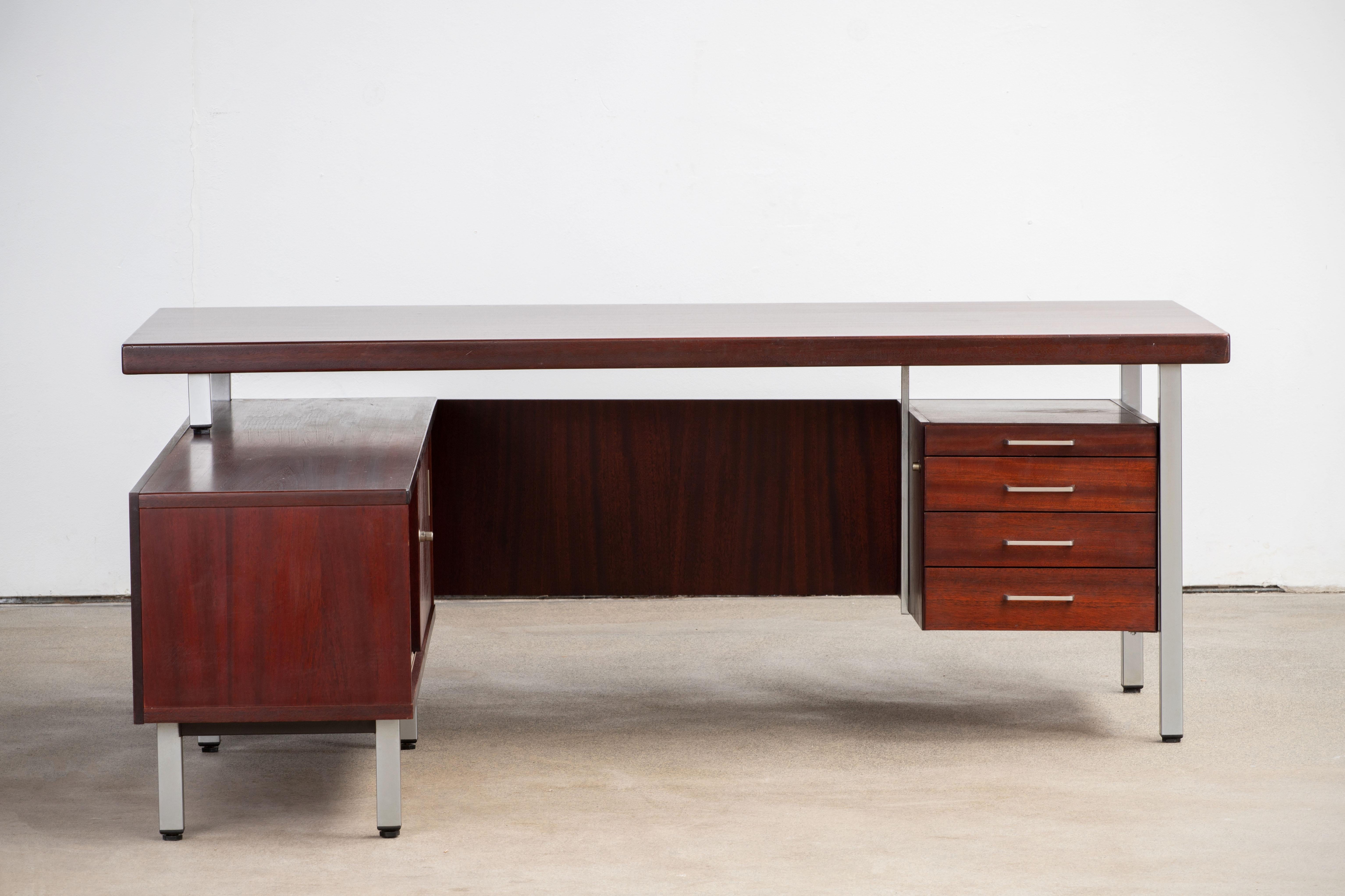 Beautifully designed writing desk in teak. With a very distinct design this desks every wood surface has been given specific angles such as the tabletop, the unit with drawers as well as the legs. The desk is given a very light and airy impression.