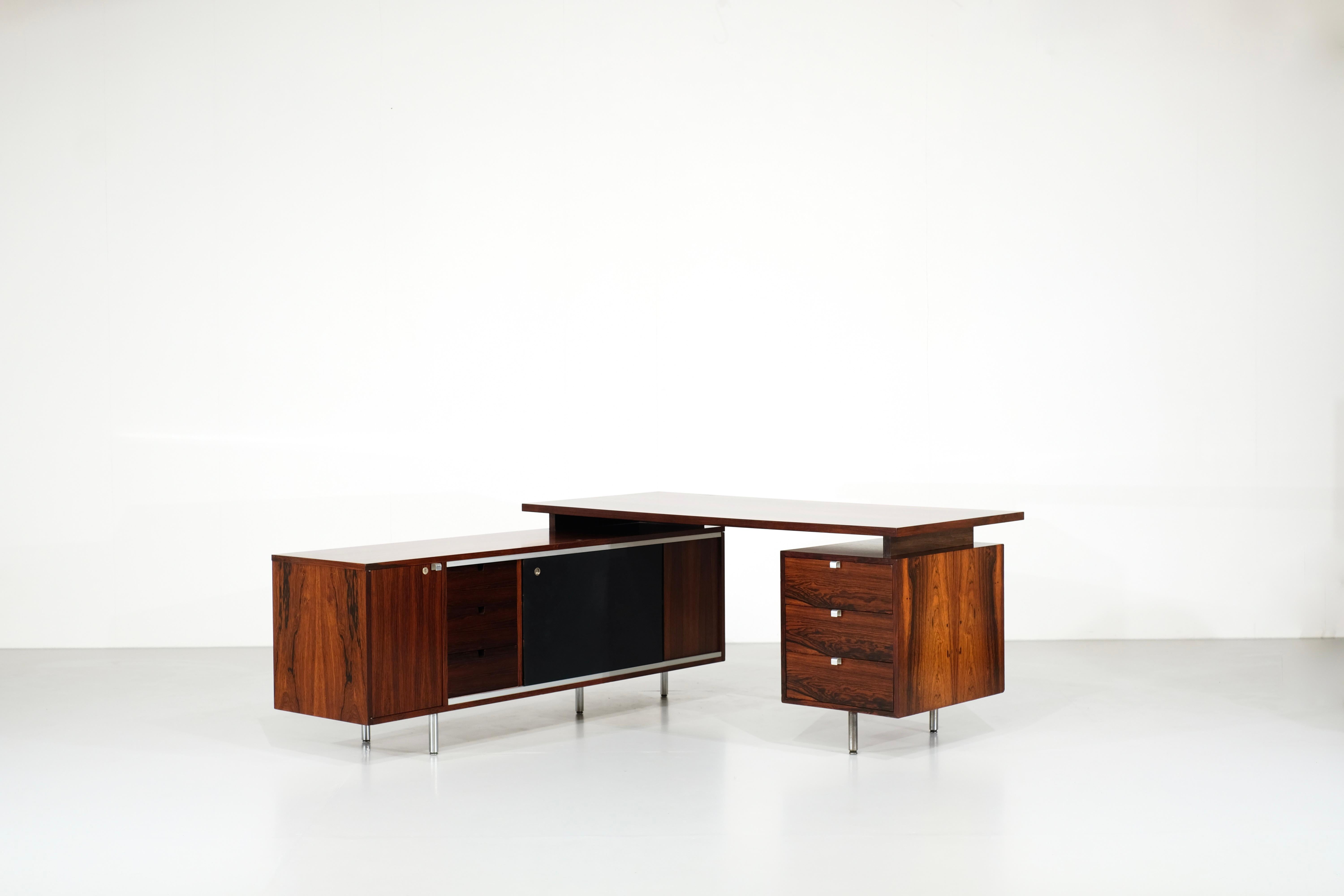 Desk in wood, serie Executive Office Group (EOG) model “9000” with  a multitude of storage compartments.
Designed by George Nelson produced for Herman Miller, 1952.

Completely renovated by a professional cabinetmaker, with a key to open the