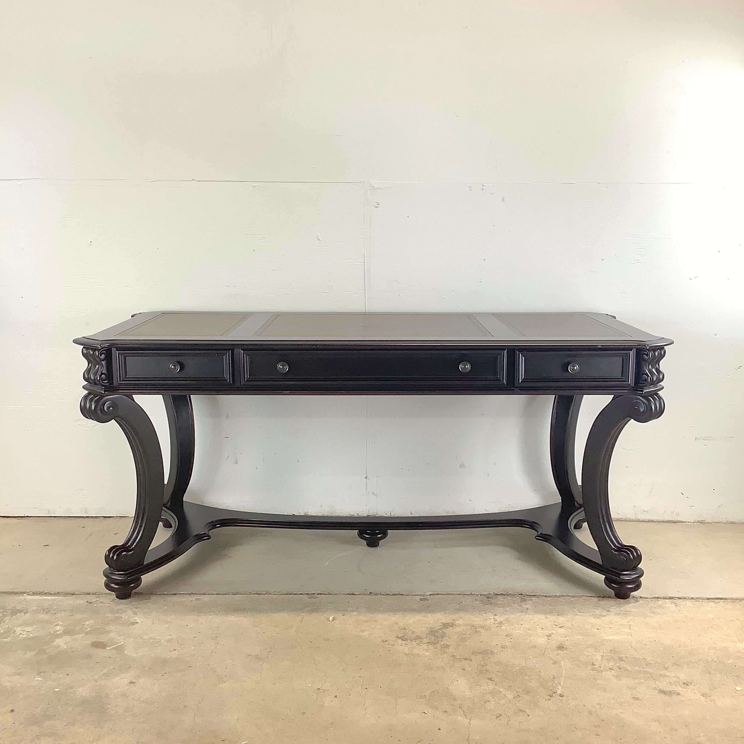 Elevate your workspace with the Hooker Furniture Leather Topped Trestle Desk, a sophisticated piece that combines sleek design with practical function. With an ebonized finish and a sumptuous leather top, this desk exudes refined style, making it a