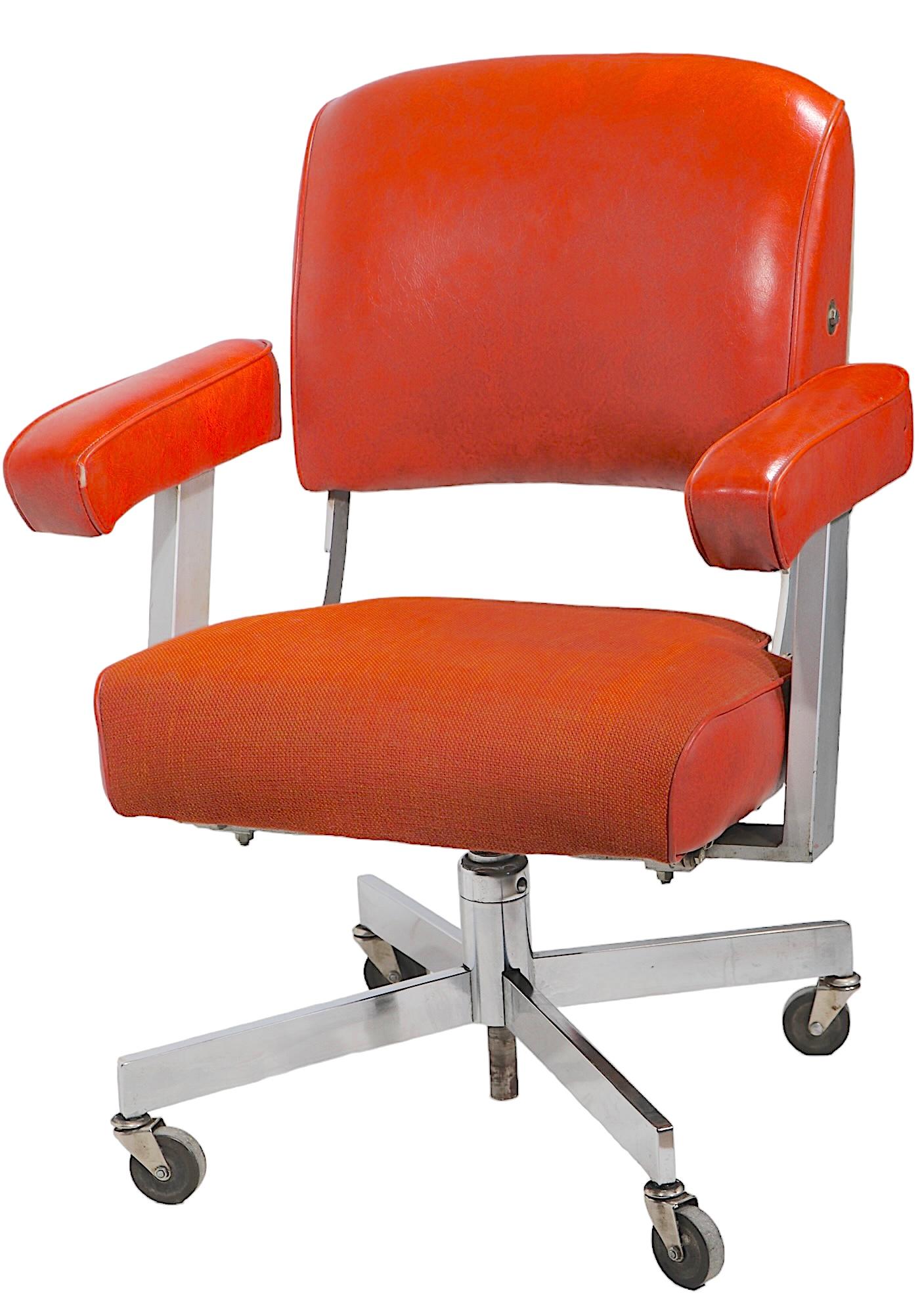 Exceptional Industrial, Mid Century  swivel office, desk chair by The  DoMore Chair Company. The chair features a chrome base on wheel castor feet, thick tweed and vinyl seat, vinyl, upholstered armrests and back support.The back support cushion