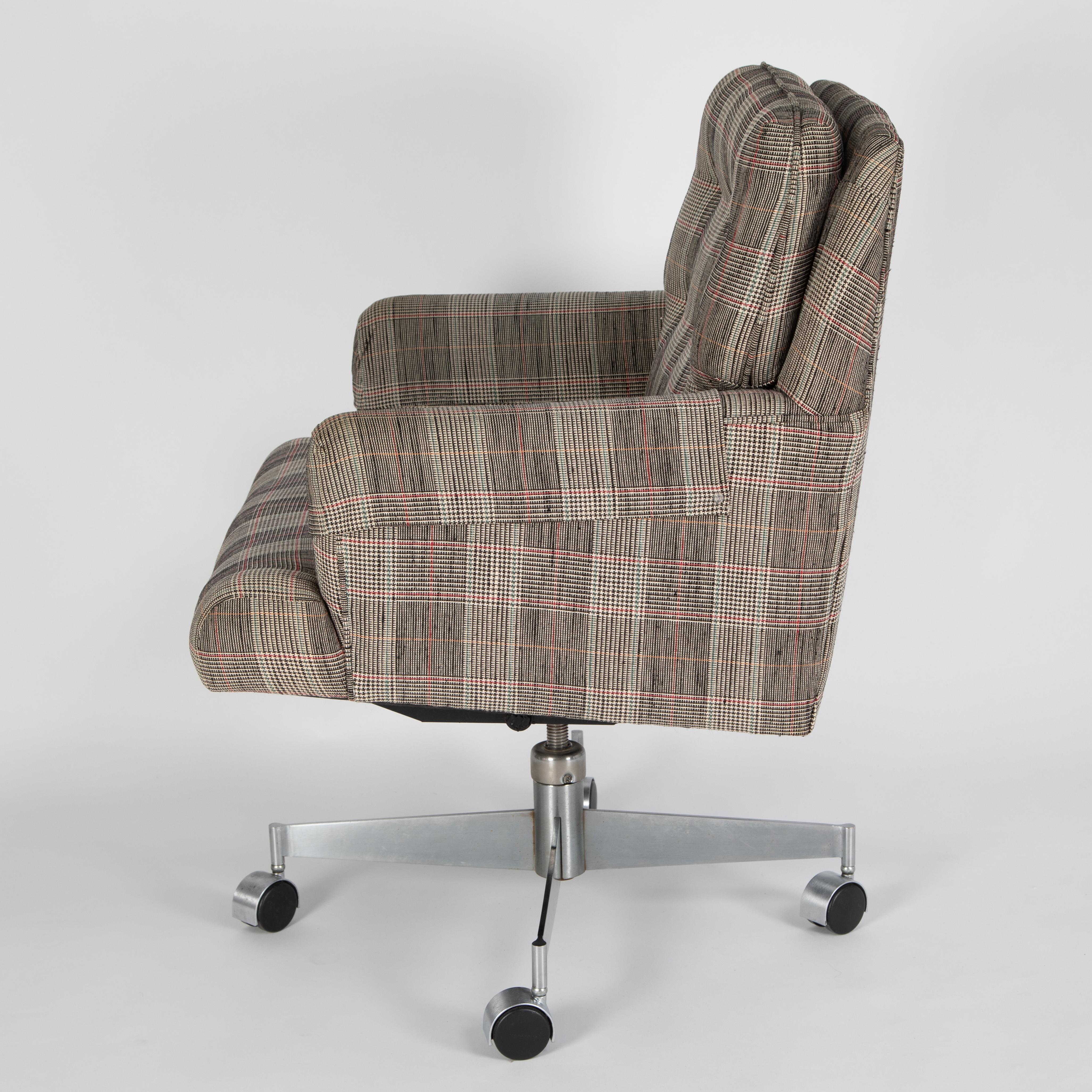 Large and comfortable executive office chair on casters by Edward Wormley for Dunbar, circa 1960s. At some point this chair has been reupholstered in a plaid fabric.