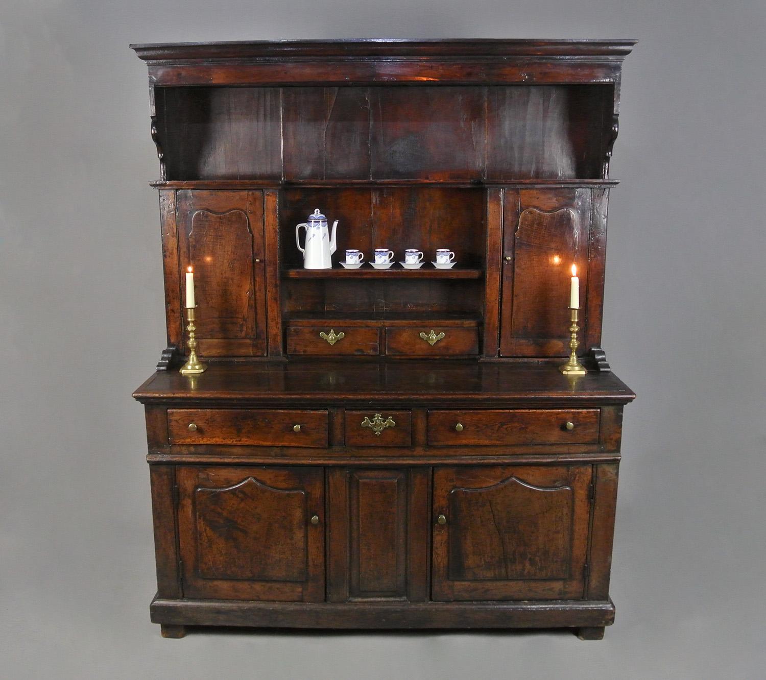 This is an original, charming and beautiful small country dresser made in Wales in c. 1750 and of exceptional colour and natural deep patination.

The dresser is peg jointed throughout – original pegs - and retains all of its original timbers