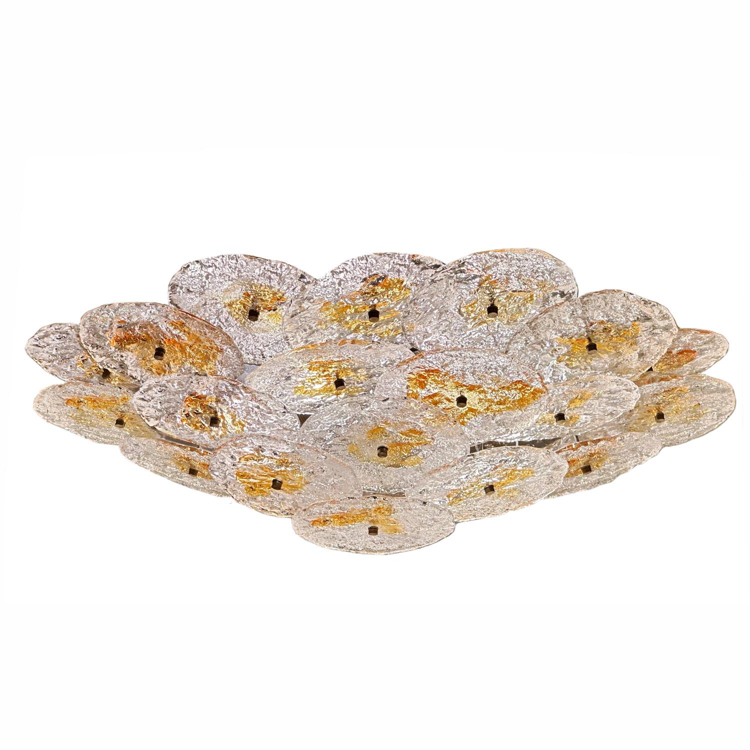 Known for it's unique blending of traditional craftsmanship and contemporary design, Mazzega offers a brutalist interpretation of the classic Murano glass disc flush mount. The result is a visually striking piece that exhibits the glass makers