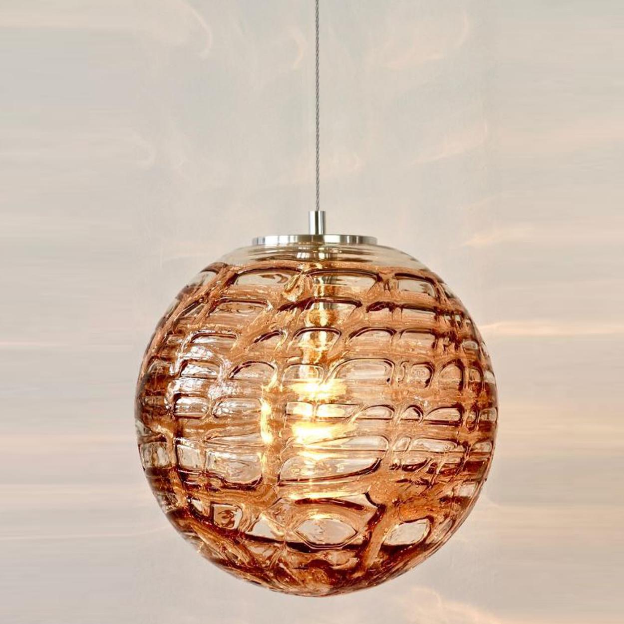 Pair of high-end Murano pendant lights in the style of Venini, manufactured, circa 1960. Real statement pieces. Heavy quality thick Murano crystal glass shade made out of overlay glasses of clear, light pink and dark pink applied in irregular