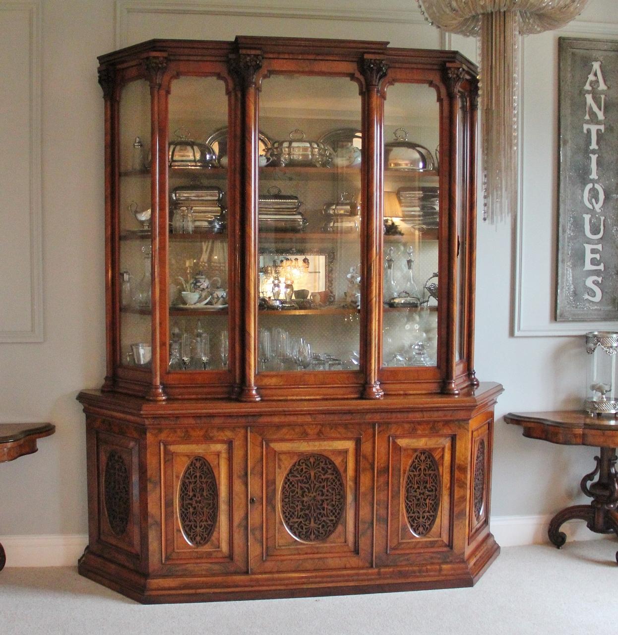 Magnificent exhibition quality antique 19th century Victorian burr walnut carved breakfront display cabinet having a wonderful breakfront glazed top with beautifully finished finely carved walnut columns ending in delightfully shaped cornices. It