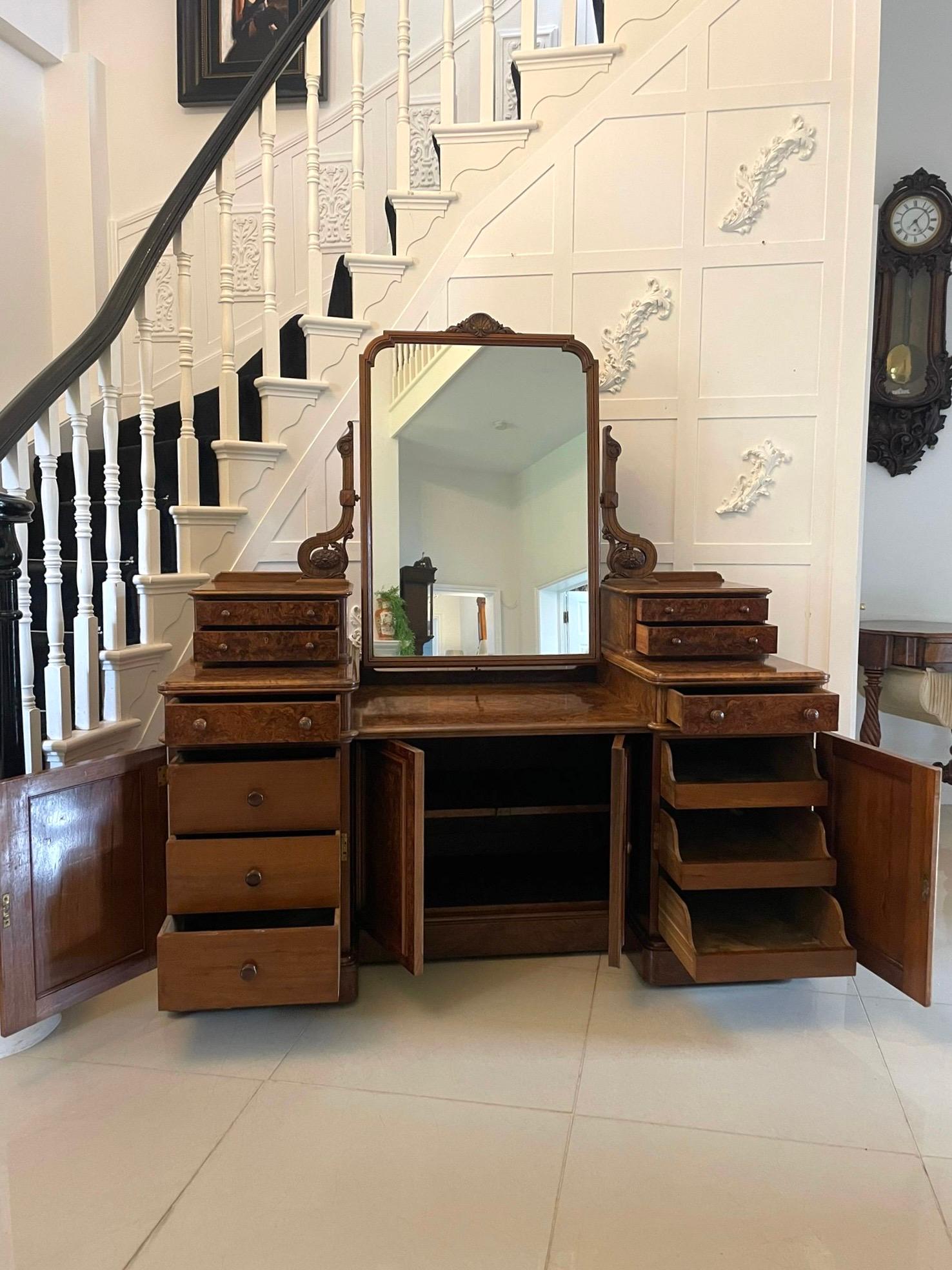 Exhibition quality antique Victorian burr walnut dressing table having a large adjustable mirror in a carved walnut frame supported by carved walnut scroll supports above four exhibition quality burr walnut small drawers with original turned walnut