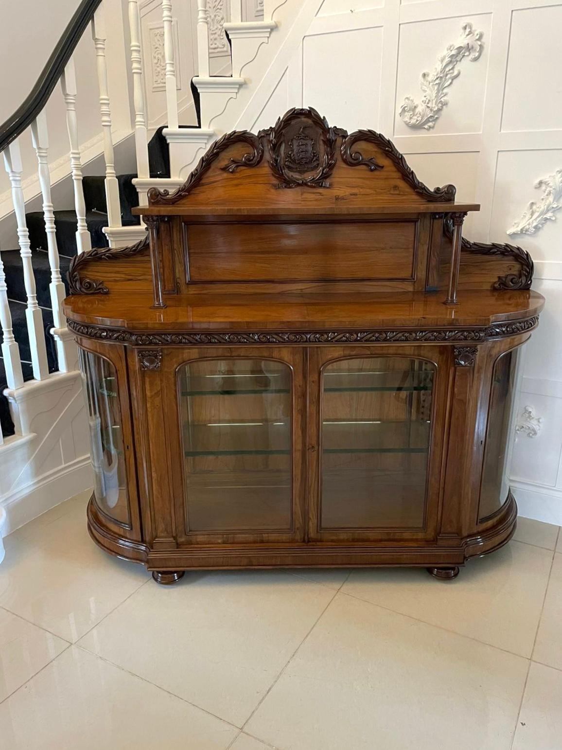 Exhibition quality antique Victorian carved olive wood credenza having an incredible exhibition quality carved solid olive wood shaped back boasting a crest depicting an arm wielding a sword above three horses and a scroll beneath with the latin