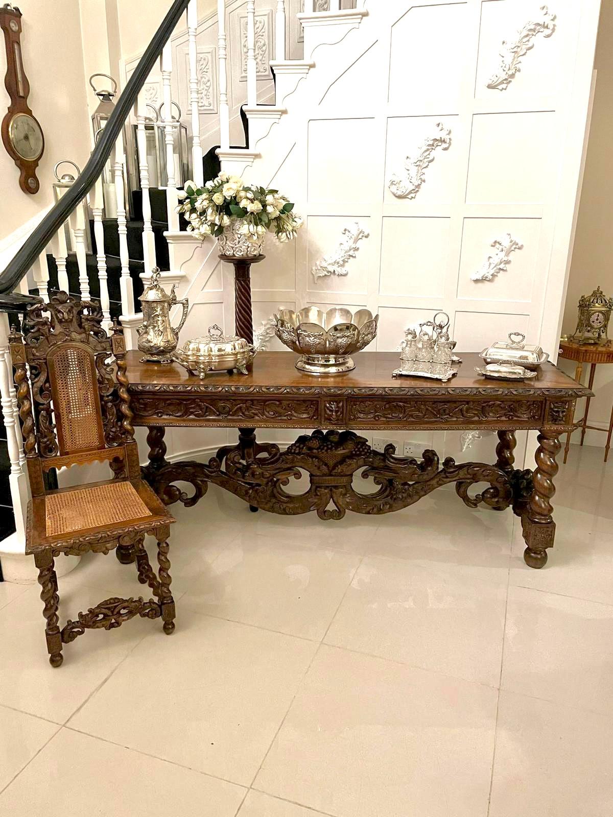 Magnificent exhibition quality antique Victorian Italian profusely carved solid figured walnut serving/console table 
having a fantastic quality solid figured walnut top with a carved edge above two beautifully carved walnut drawers with carved