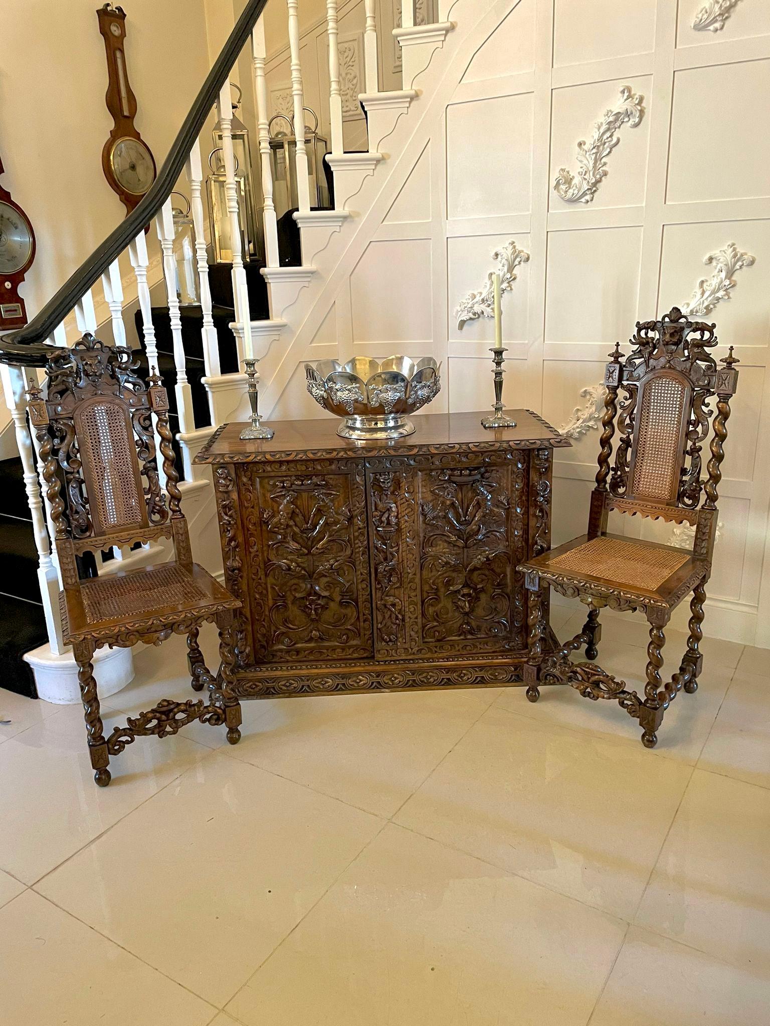 Magnificent exhibition quality antique Victorian Italian profusely carved solid walnut pair of side cupboards
having superior quality figured walnut tops with a carved edge above a pair of cupboard panel doors with exhibition quality carvings of