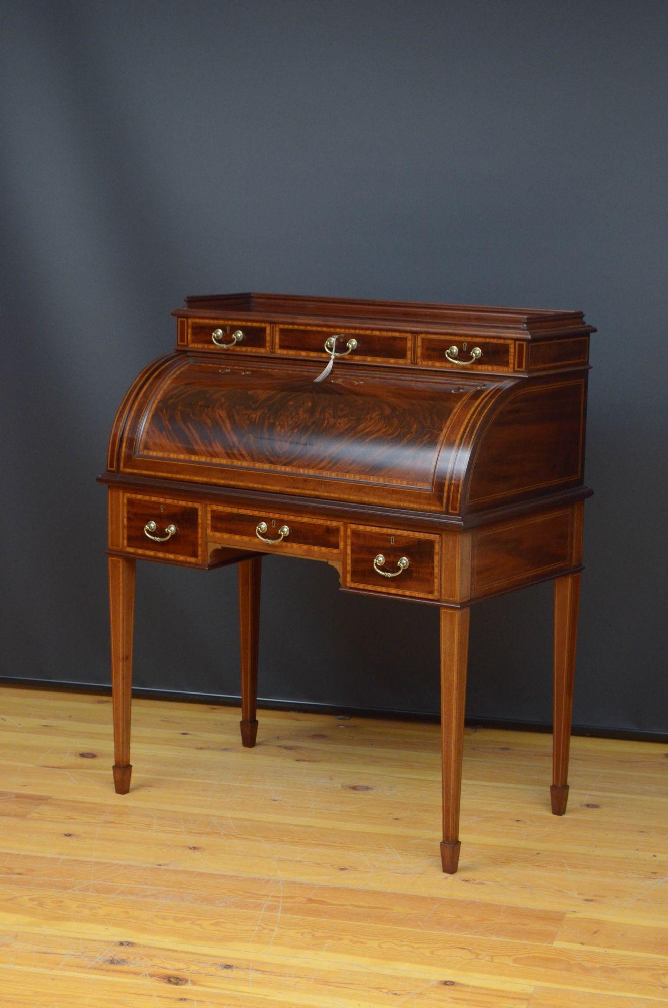 Sn5493 Superb quality and very attractive, late Victorian flamed cylinder bureau by Maples & Co, having fine carved gallery to top above three mahogany lined and satinwood crossbanded drawers fitted with original brass handles and cylinder front