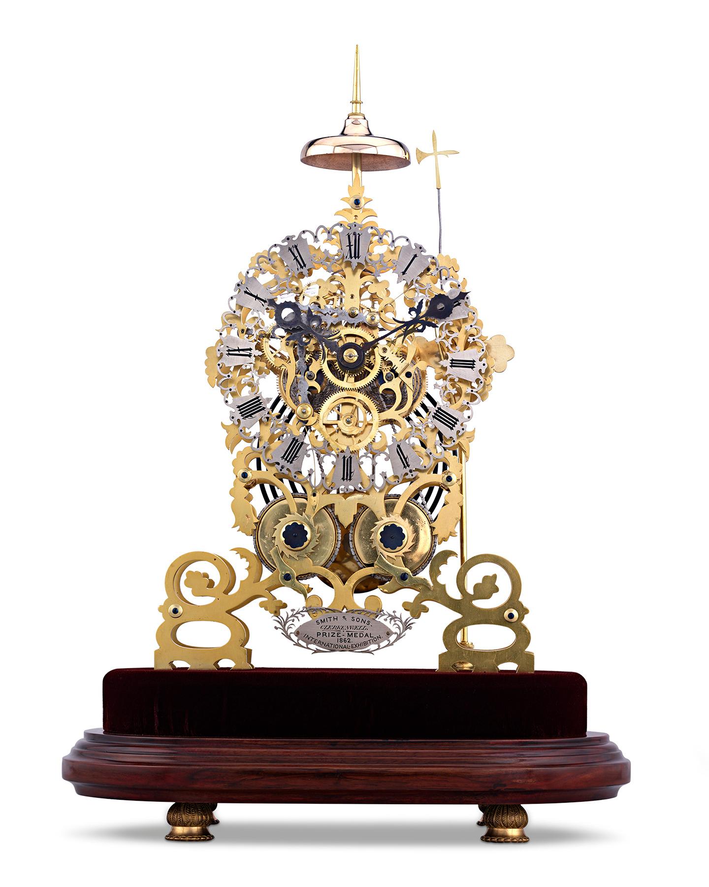 This exceptionally rare and early skeleton clock is a work of true horological mastery. Crafted by J. Smith & Sons of Clerkenwell, the impressive timepiece was prominently displayed at the 1862 International Exhibition in London, where the firm was