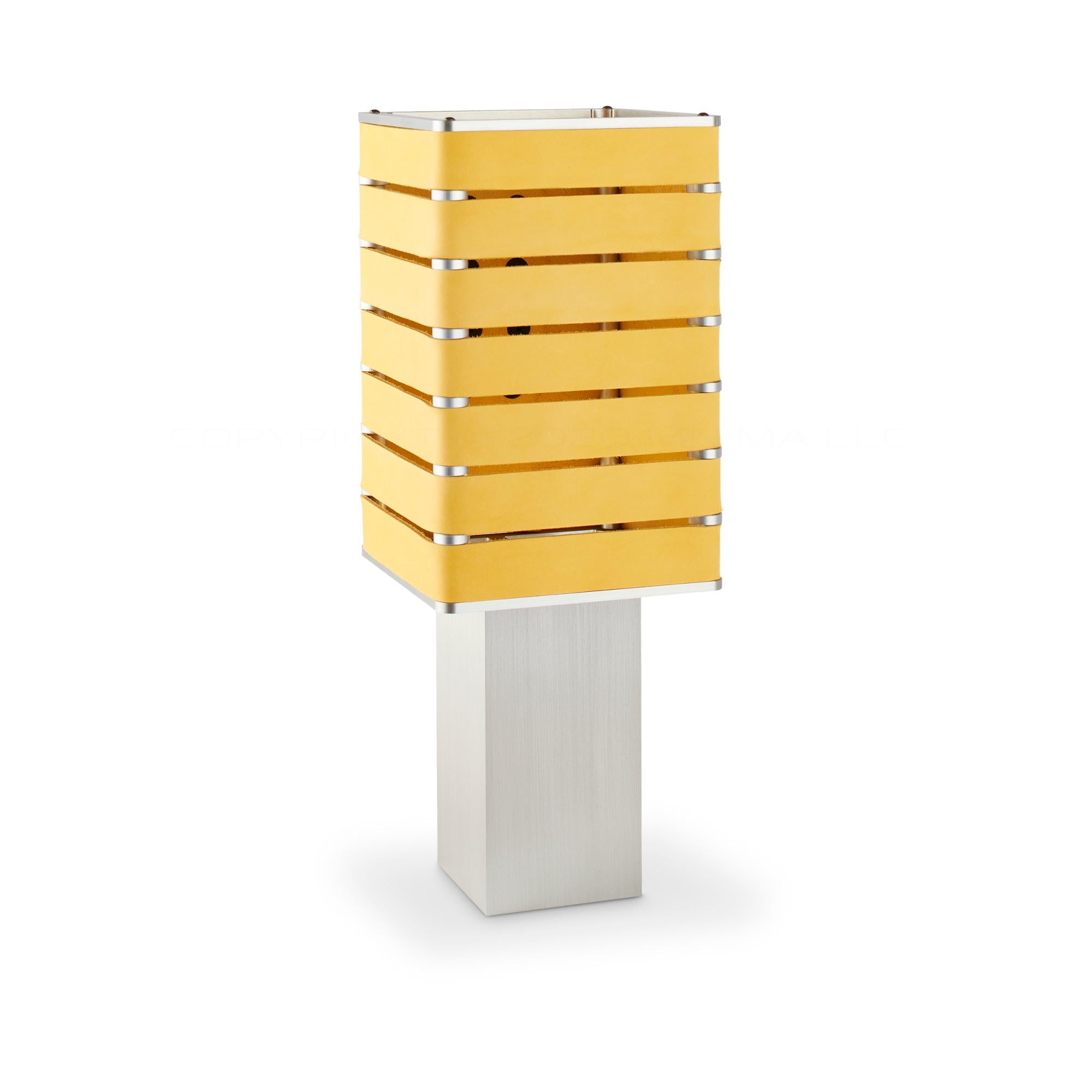 Modern, Minimal, Solid Metal Table Light in Limon Yellow Italian Leather with Matte Black Snaps.

Introducing Exigen, the customizable lighting platform from mnima.  Presented in an array of crisp, eye-catching colors, Exigen offers maximum