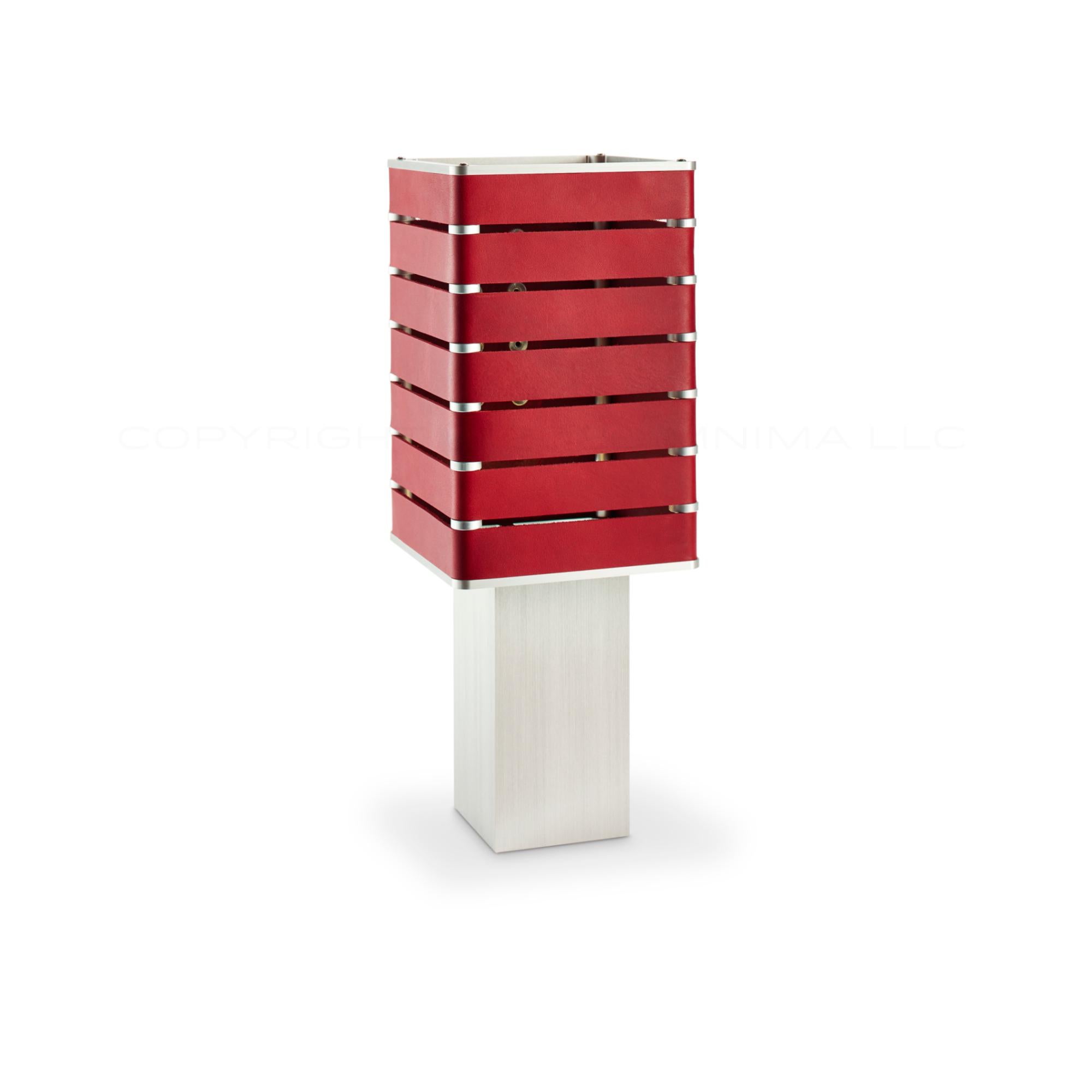 Modern, Minimal, Solid Metal Table Light in E. Fiesta Red Italian Leather with Nickel Plate Snaps.

Introducing Exigen, the customizable lighting platform from mnima.  Presented in an array of crisp, eye-catching colors, Exigen offers maximum