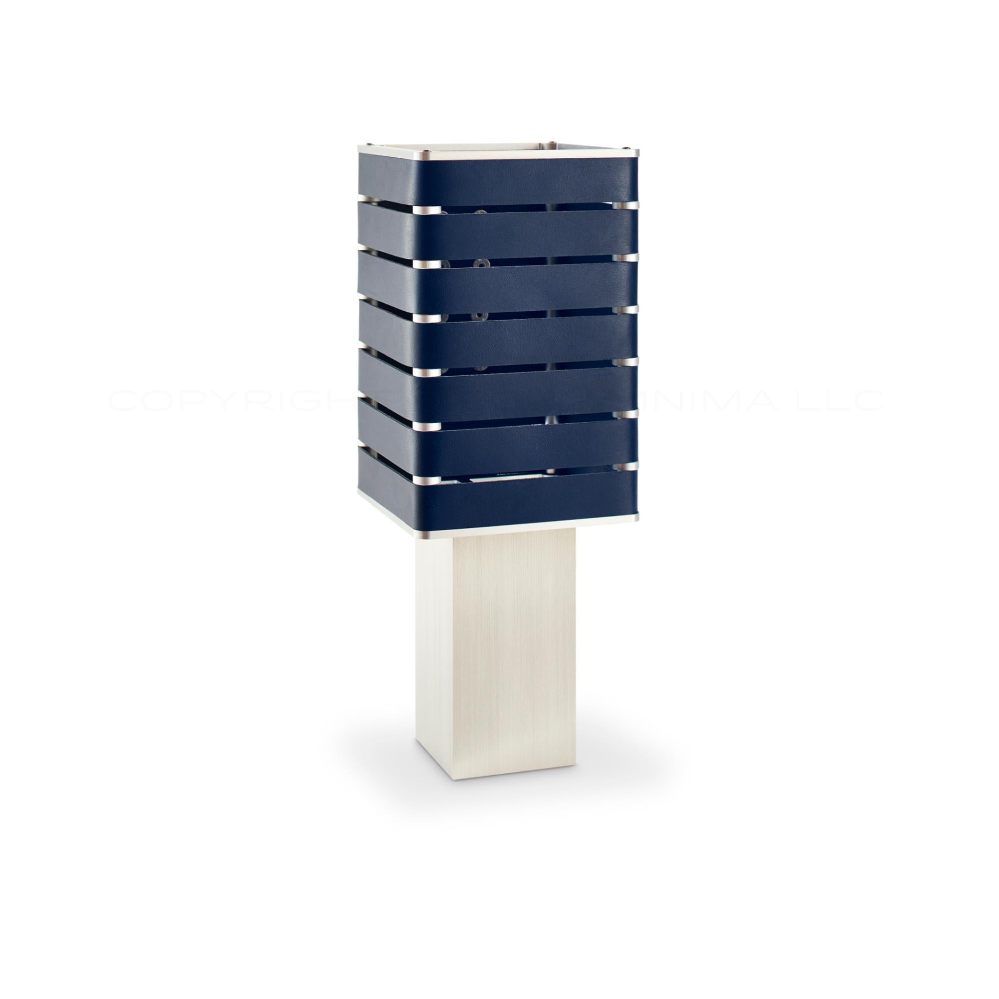 Modern, Minimal, Solid Metal Table Light in Navy Blue Italian Leather with Nickel Plate Snaps.

Introducing Exigen, the customizable lighting platform from mnima.  Presented in an array of crisp, eye-catching colors, Exigen offers maximum