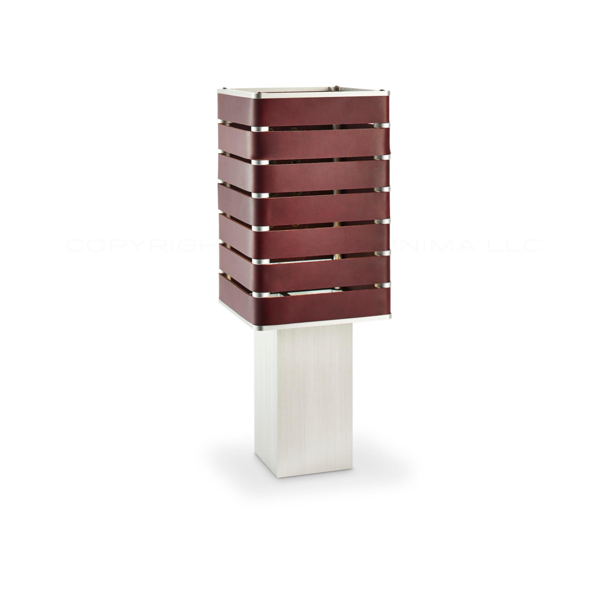 Modern, Minimal, Solid Metal Table Light in Siena Brown Italian Leather with Antique Brass Snaps.

Introducing Exigen, the customizable lighting platform from mnima.  Presented in an array of crisp, eye-catching colors, Exigen offers maximum