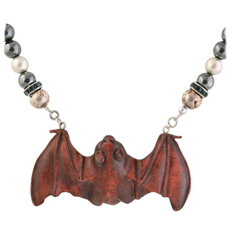 Exolette Agate Necklace Holding a Hand Carved Wooden Netsuke Bat For Sale