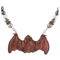 Exolette Agate Necklace Holding a Hand Carved Wooden Netsuke Bat