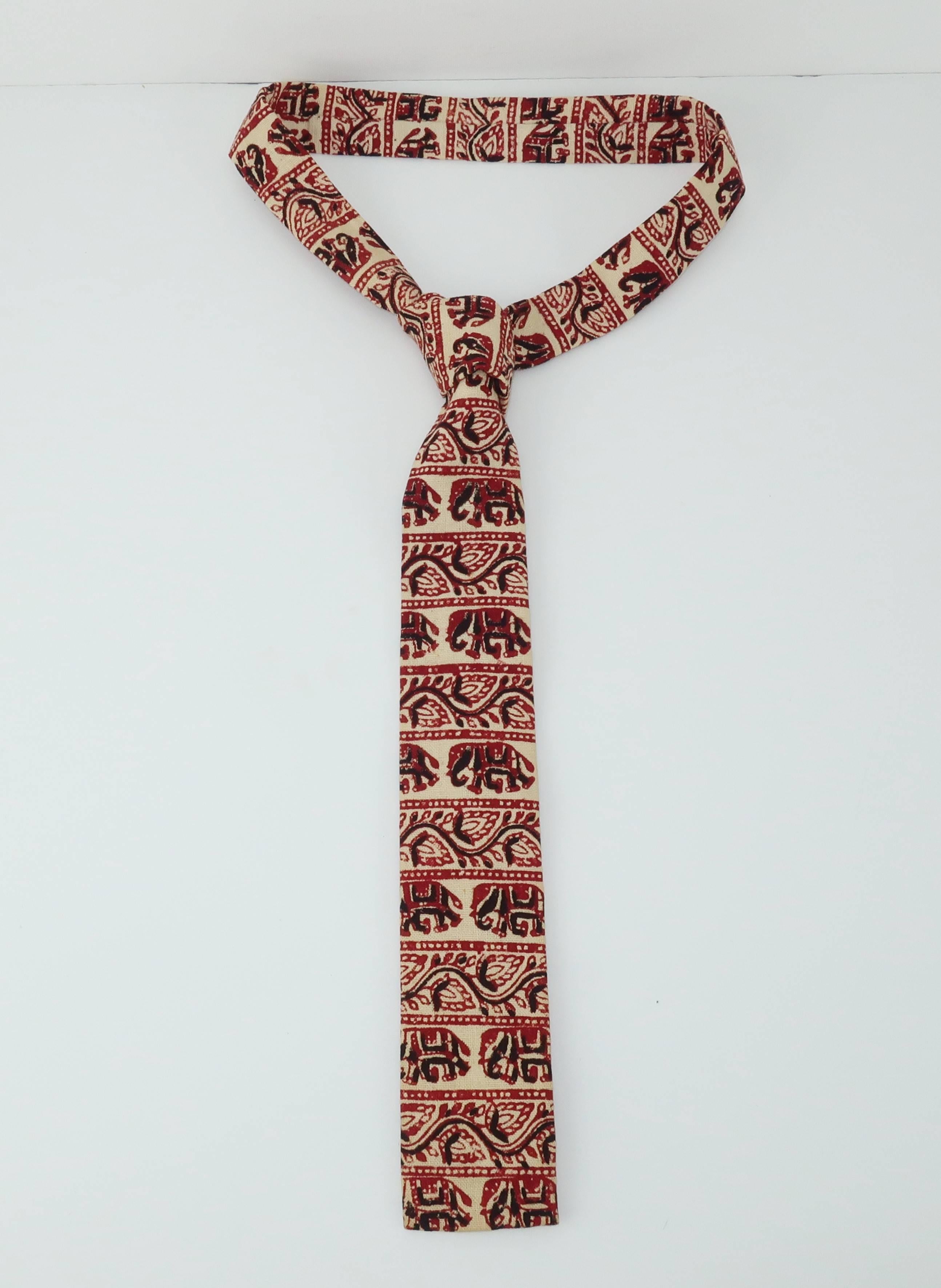 The novelty necktie can be the perfect accessory for a gentleman with a sense of humor and an eye for whimsy. This 1960's skinny square tie by Tucker Ties is designed with hand blocked Indian fabric.  The natural white background is accented in