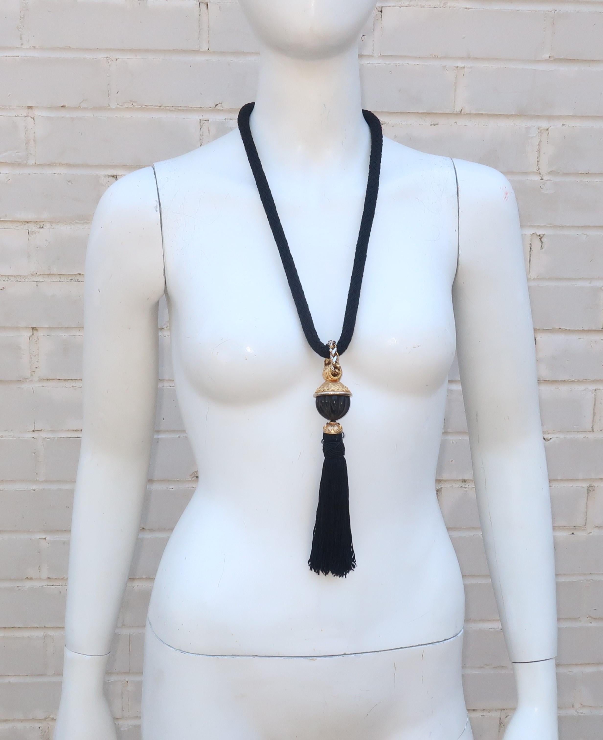 This 1970's piece is a fashionable two-for-one ... a necklace for some occasions with a quick change to a belt for other looks.  The braided black silk 'rope' is perfectly at home around the neck or at the waist with a chunky tasseled medallion