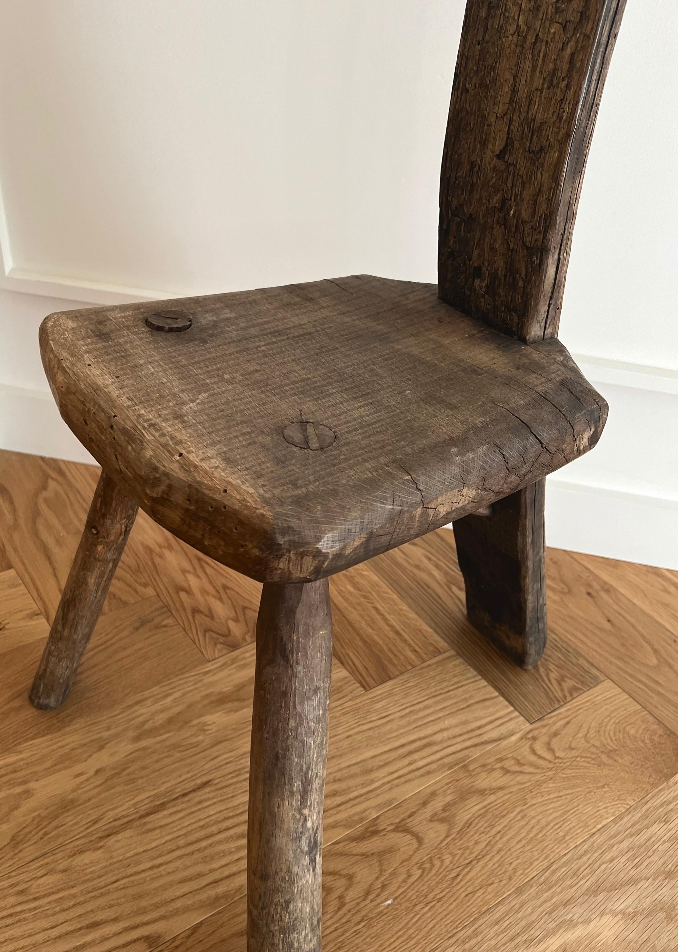 Exotic African Accented Primitive stool in rich, dark patina.