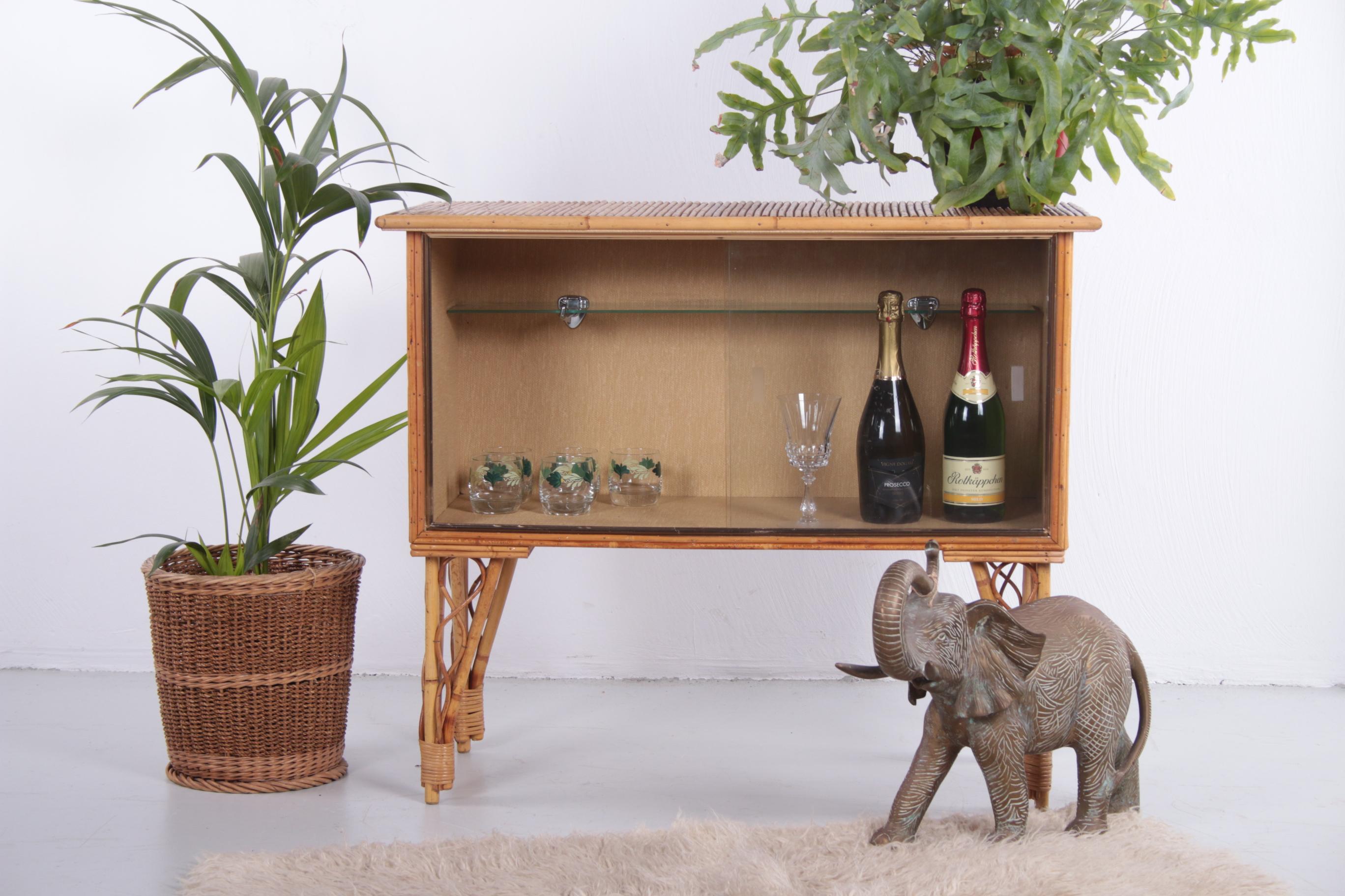 This is a stylish bamboo bar with glass sliding doors. The cabinet is from France and is made of beautiful thin bamboo. There is also an original glass shelf to place glasses on and the inside is lined with a light structure.

Do you want a summer