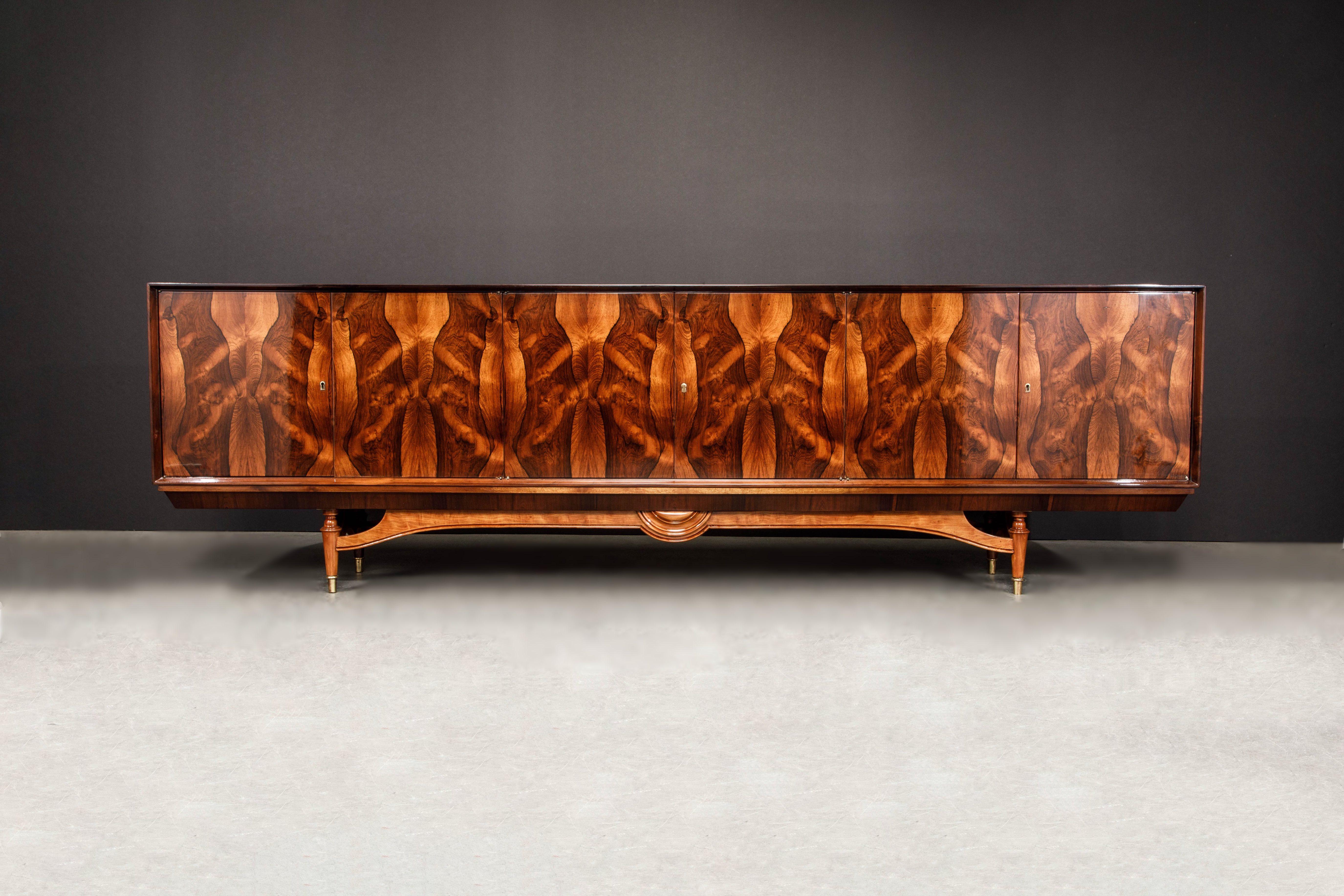 A breathtaking and (very) exotic sideboard credenza attributed to Giuseppe Scapinelli, crafted in 1950s Brazil. This showstopper will take center stage of any room with its six book-matched Brazilian Rosewood doors which have an exotic butterfly