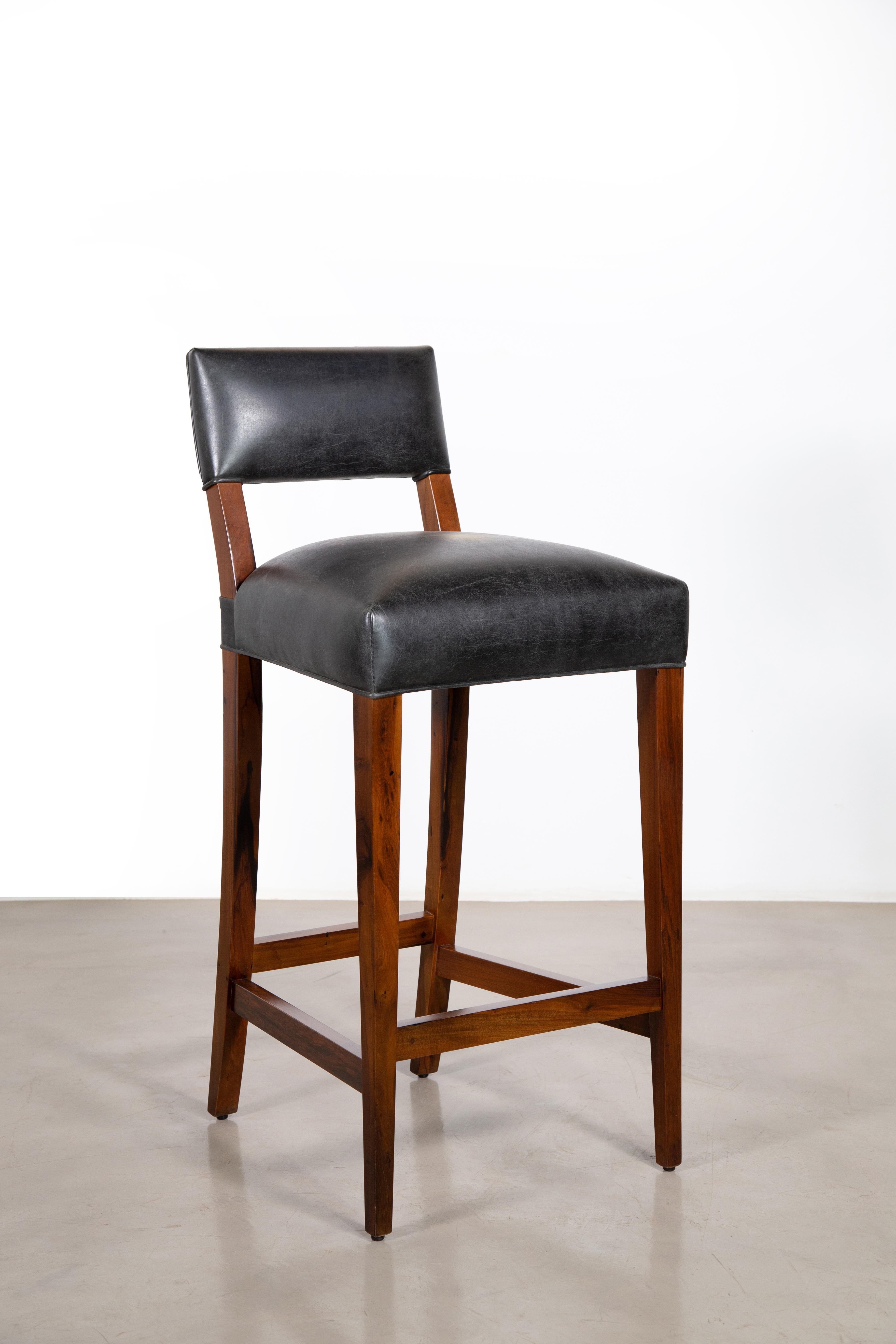Costantini prides itself in using the hardest and most beautiful hardwoods in the construction of its line of seating. The Neto Stool has a gently curved, relatively low back leg, with sleek, straight front legs and stretchers, with a bronze or