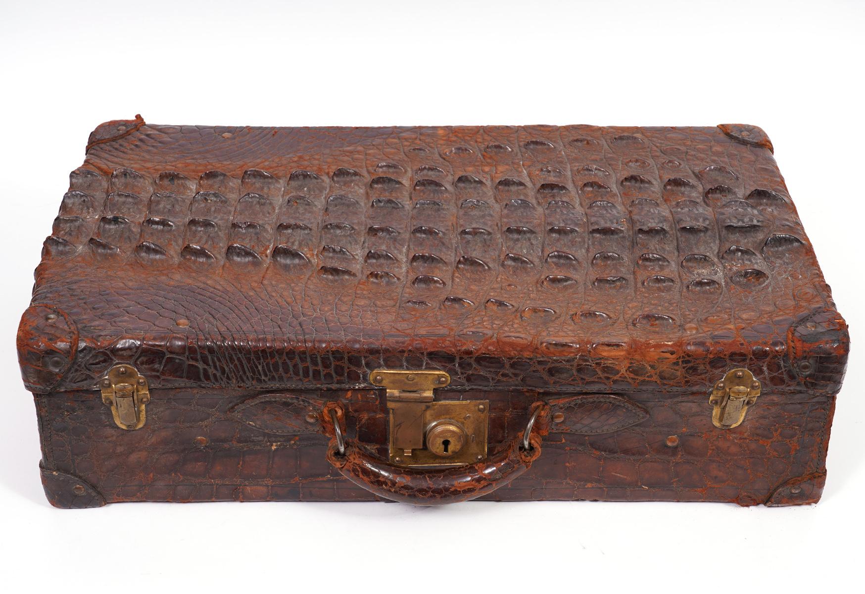 The right term is a small suitcase, measuring 24 x 15 x 7 inches. On the top and the ends it shows the sculptural back skin of the animal lengthwise, on the other sides the more even belly skin. The front is mounted with brass lock and handle